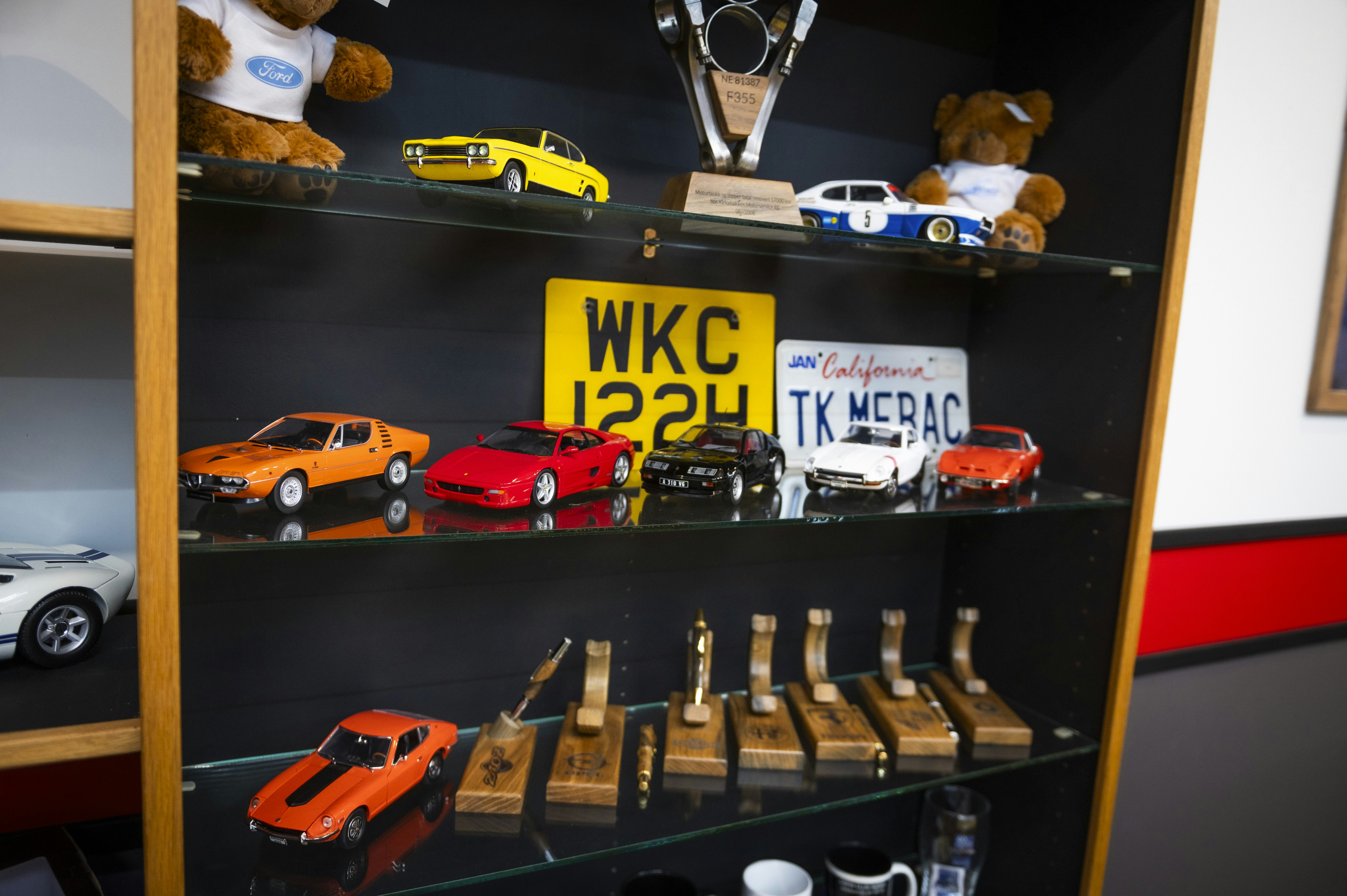 Shelf with car models and trophies