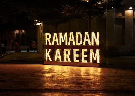 Ramadan kareem is illuminated at night.