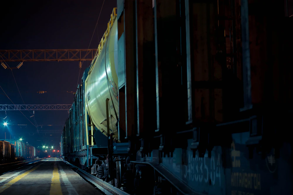 Railway carriages standing in a dimly lit railway yard