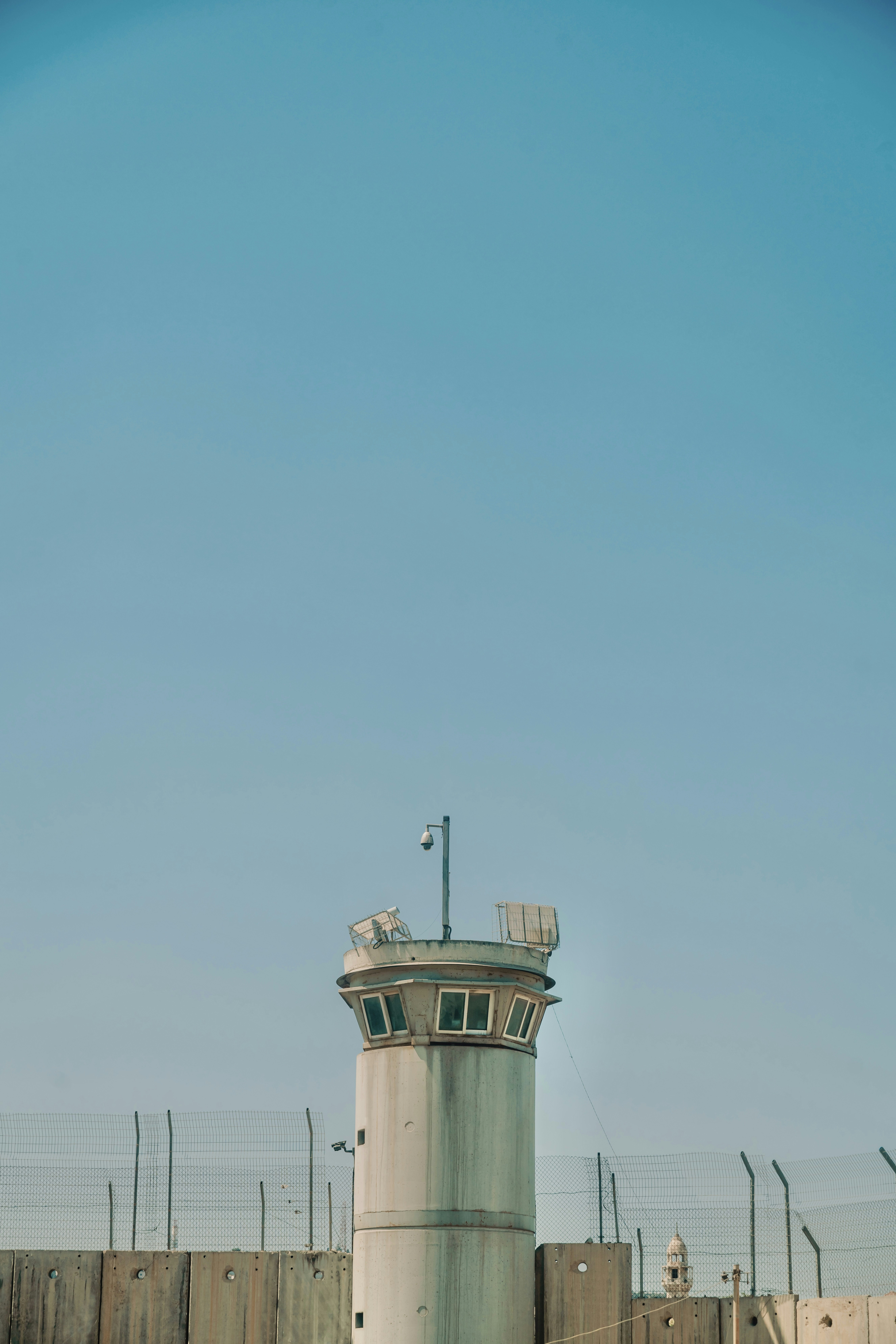 Watchtower stands against a clear, blue sky.