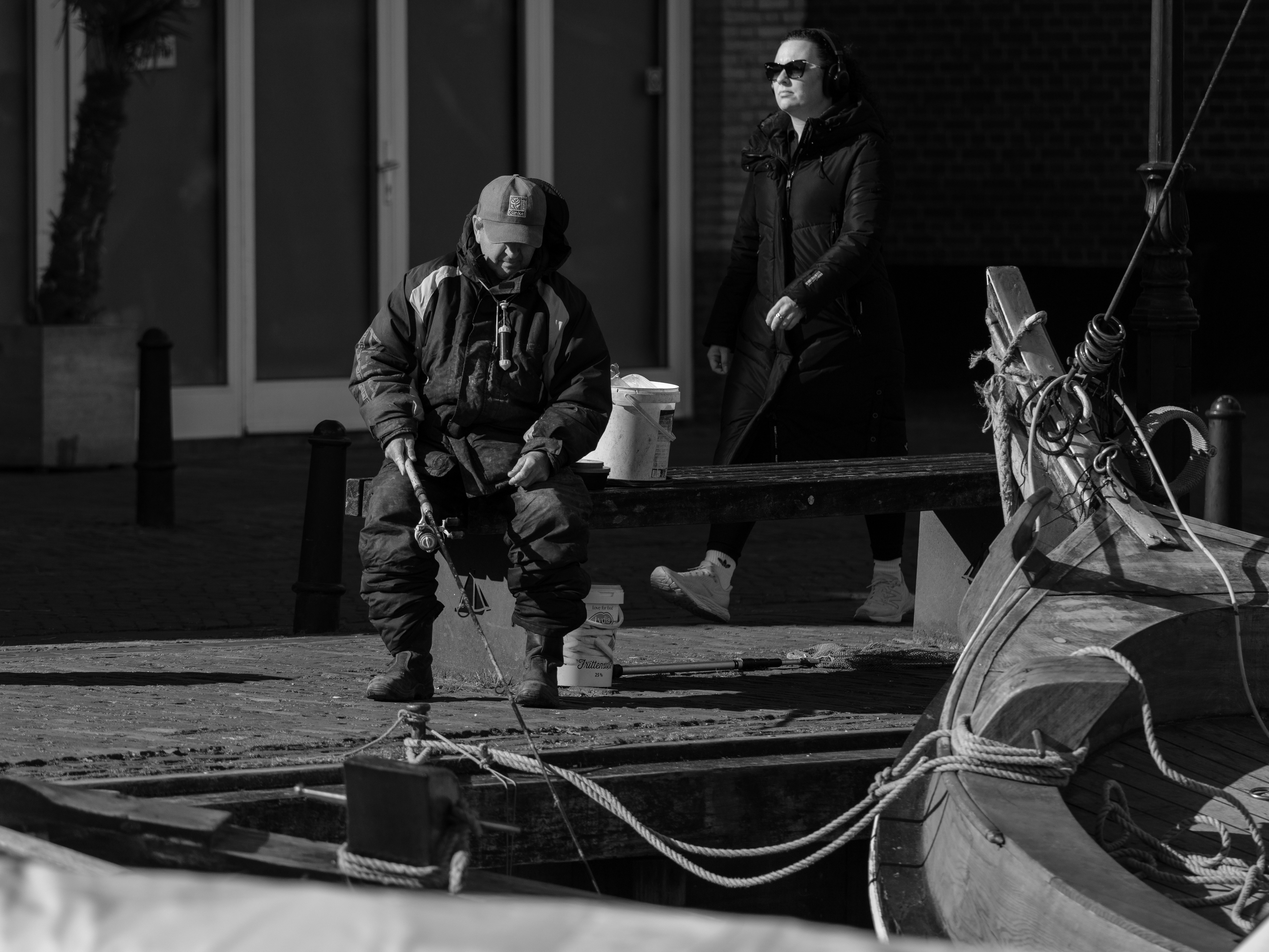 A marine construction professional carefully inspecting the underside of a dock, checking pilings and structural integrity - boat dock repair