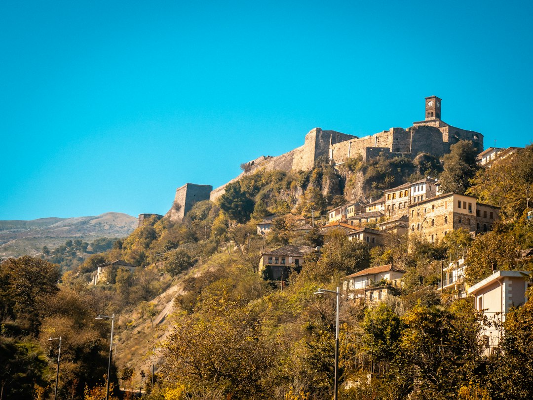 A castle sits high on a hillside.