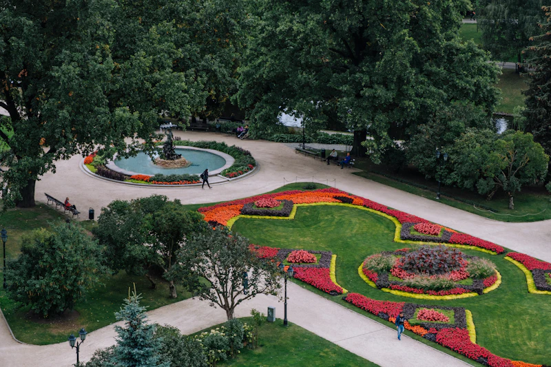 Colourful flower beds and fountain in a green city park in Latvia