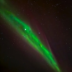 A vibrant aurora borealis lights up the night sky.
