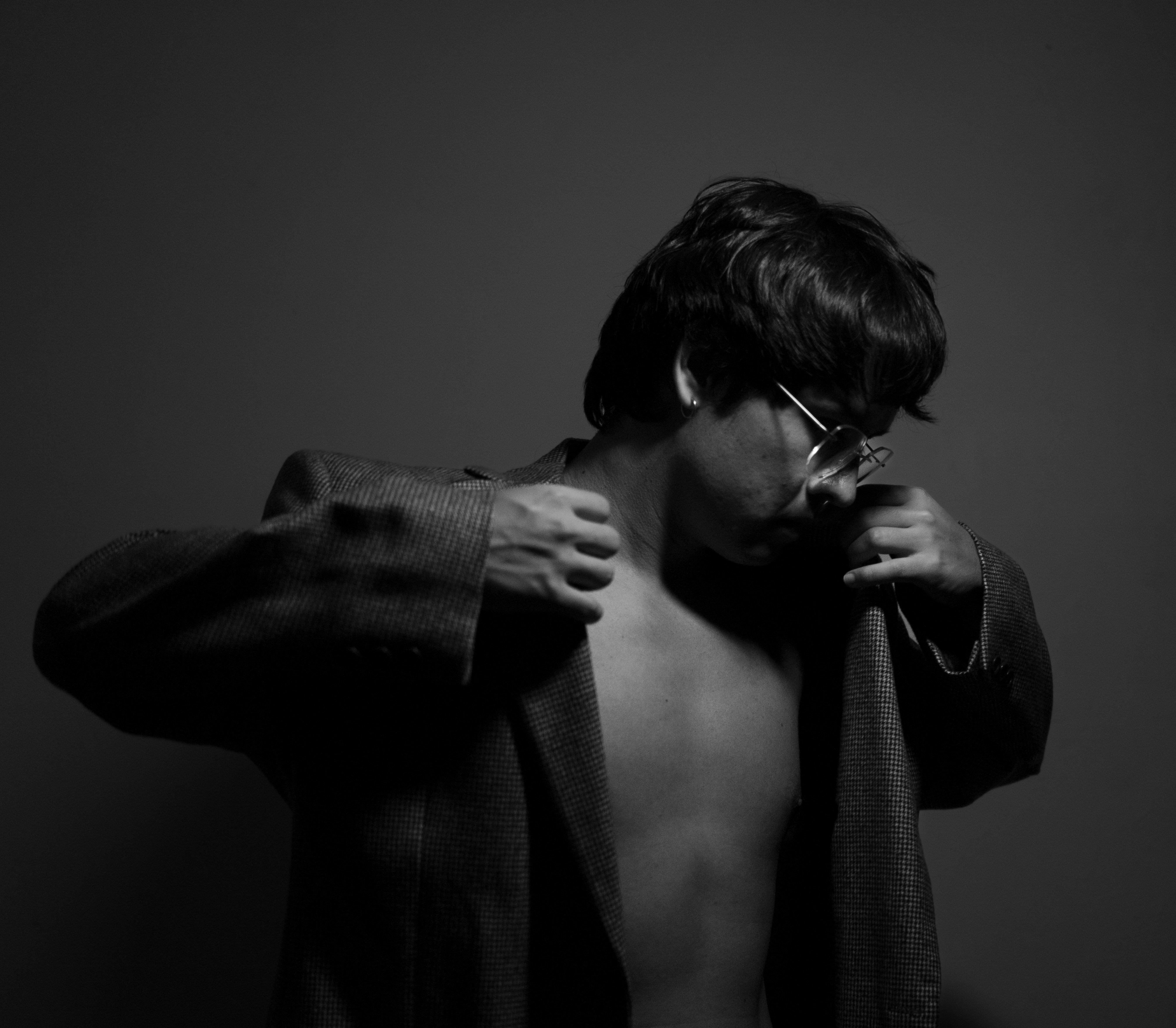 Man in jacket posing with bare chest.