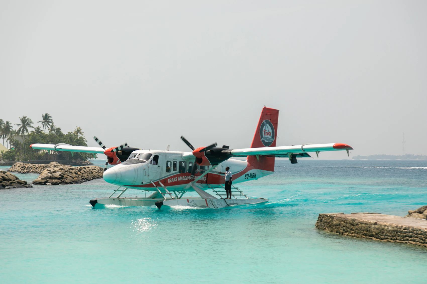 A seaplane resting on clear turquoise water in the Maldives