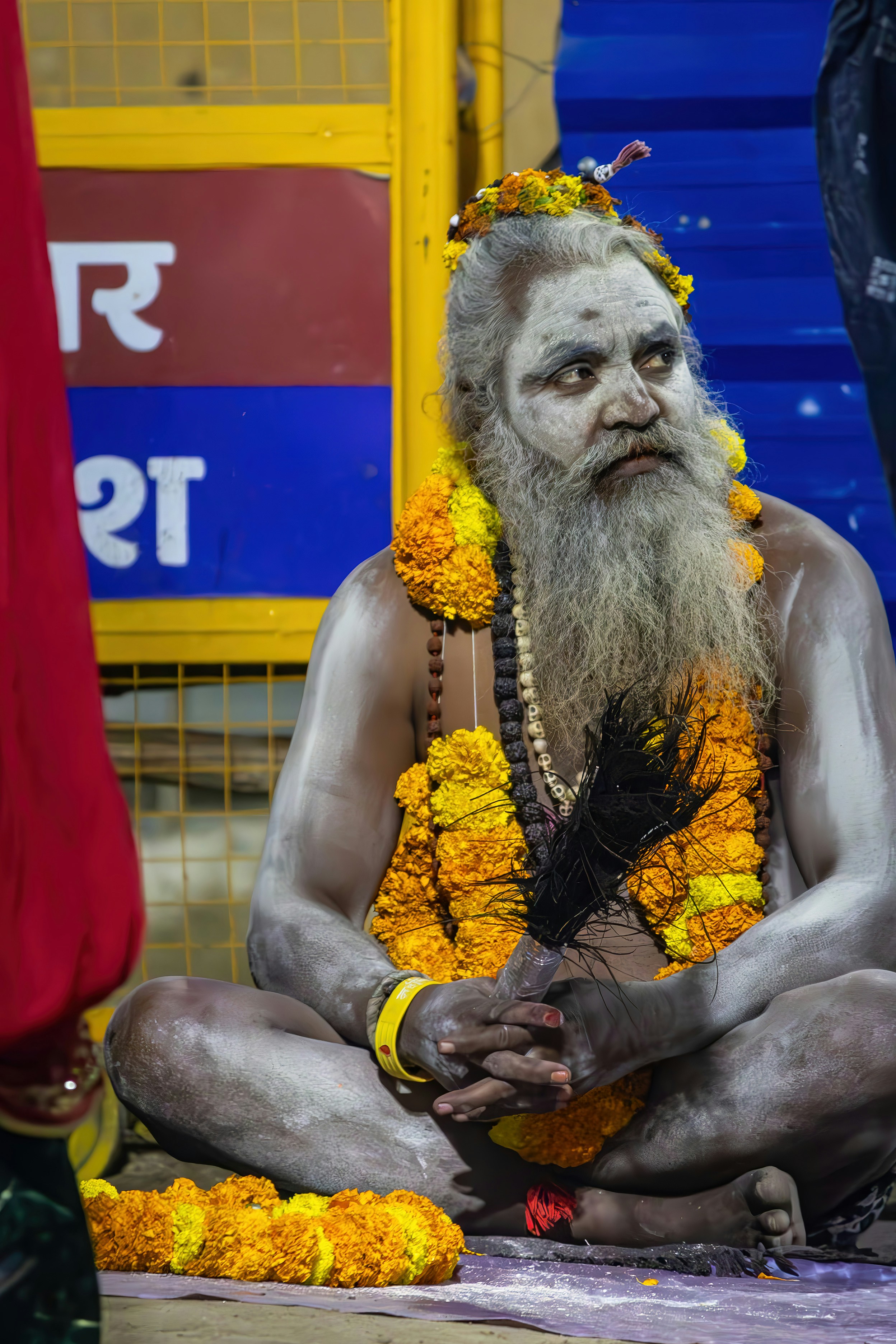 A sadhu with face and body painted white.