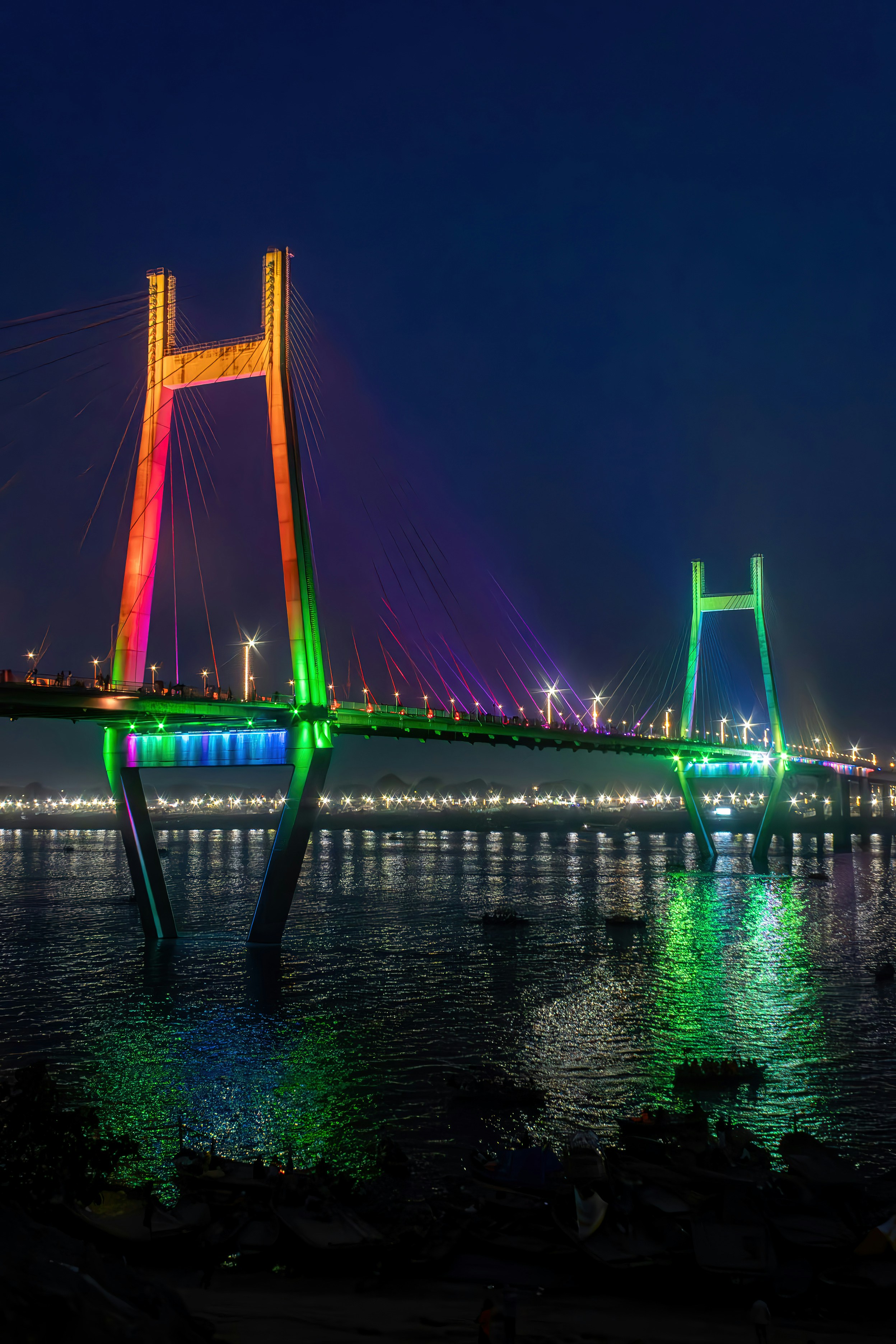 A brightly lit bridge glows at night.
