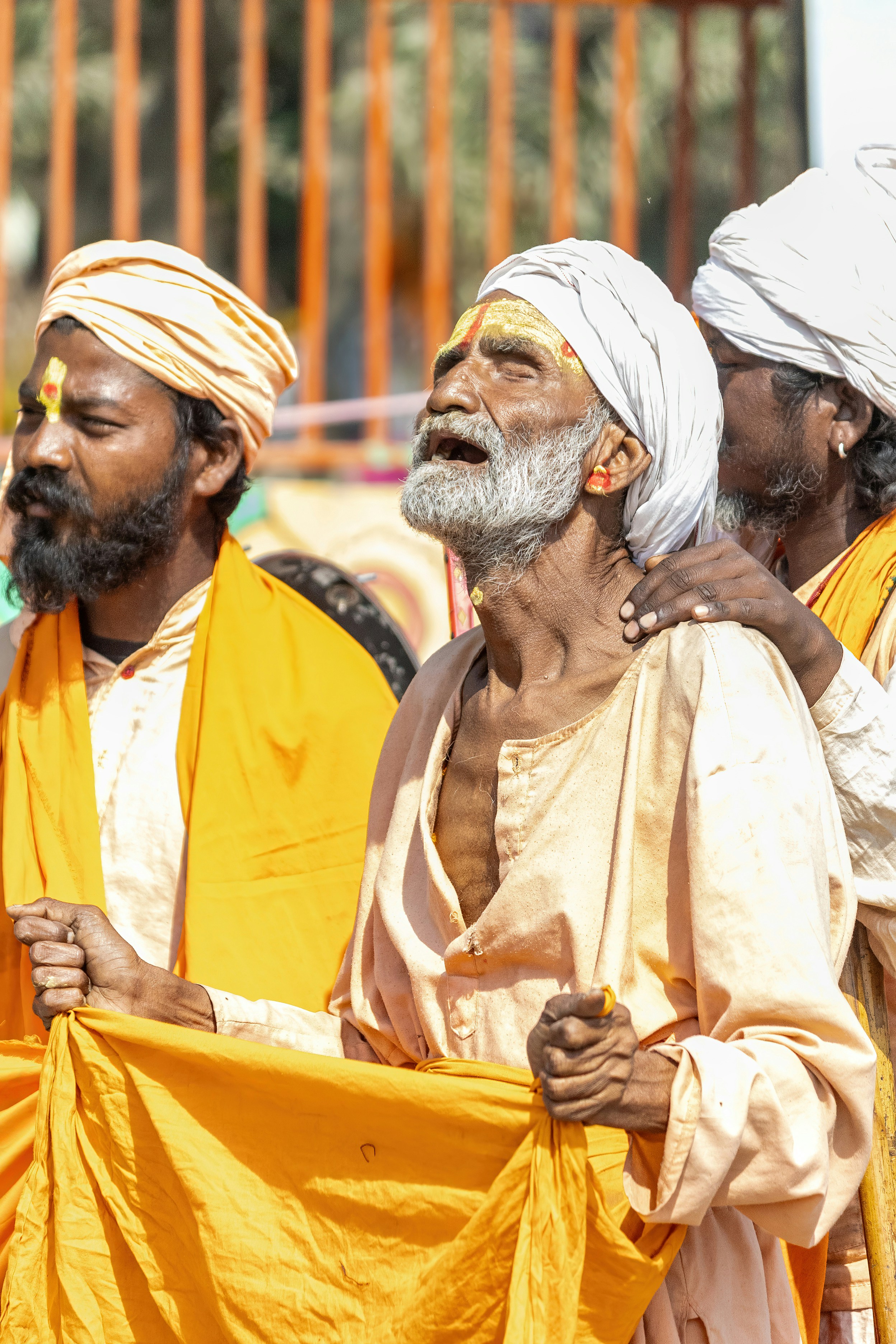 Hindu men in traditional clothing appear distressed.