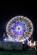 A brightly lit ferris wheel at night.