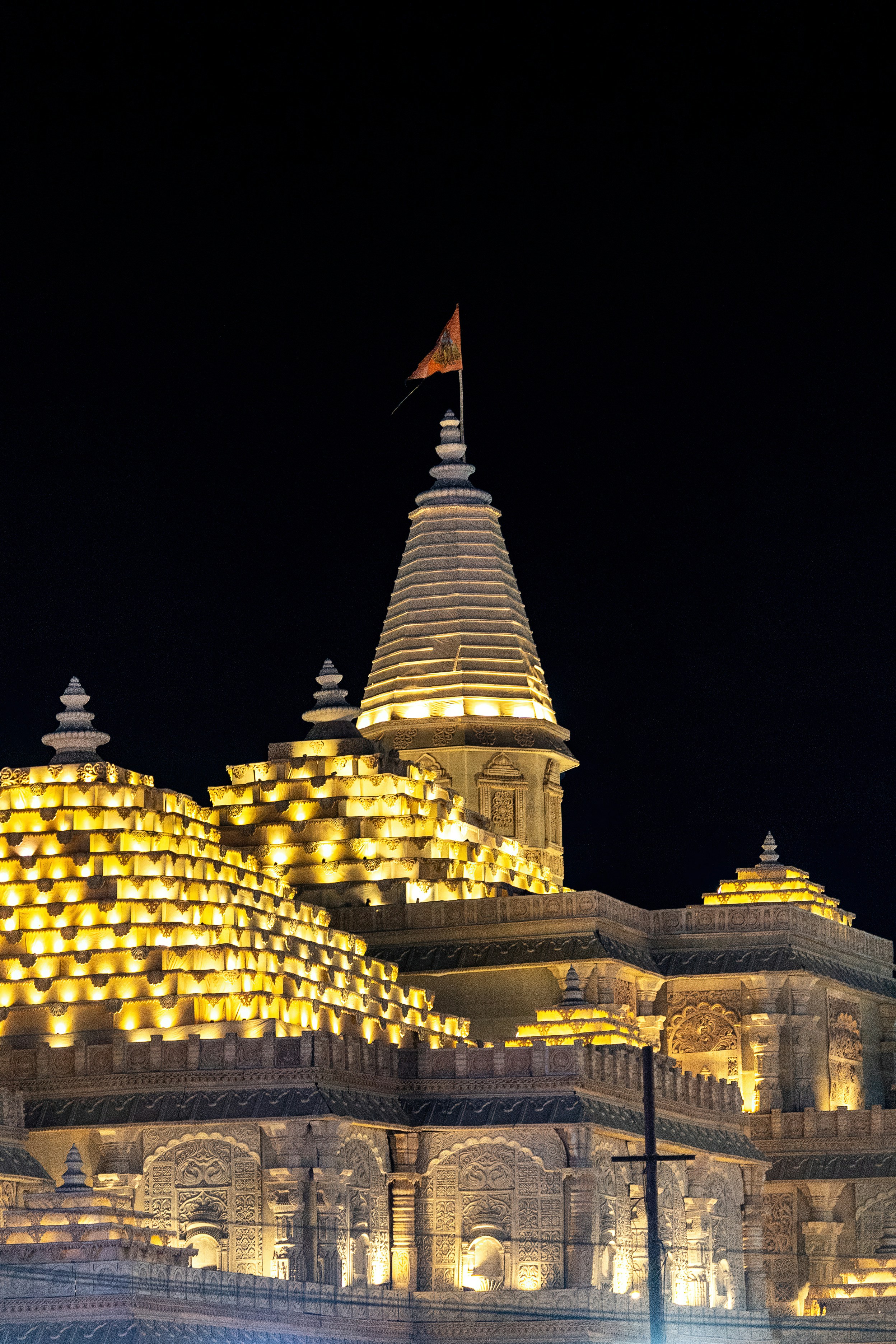 A lit-up temple stands tall against the night