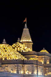 A lit-up temple stands tall against the night.