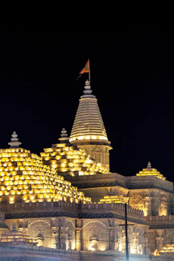 A lit-up temple stands tall against the night.