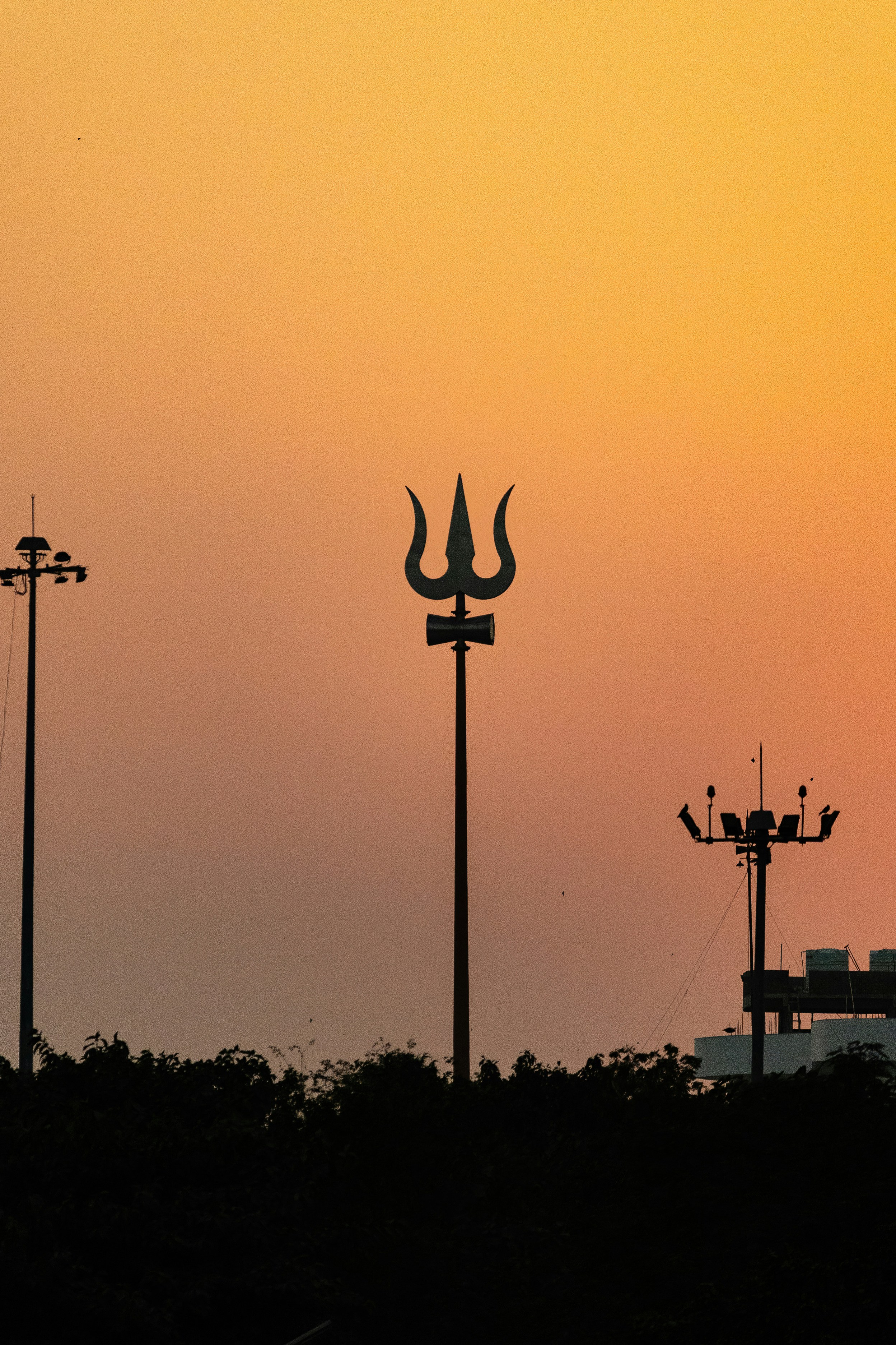 Trident silhouetted against the sunset sky.