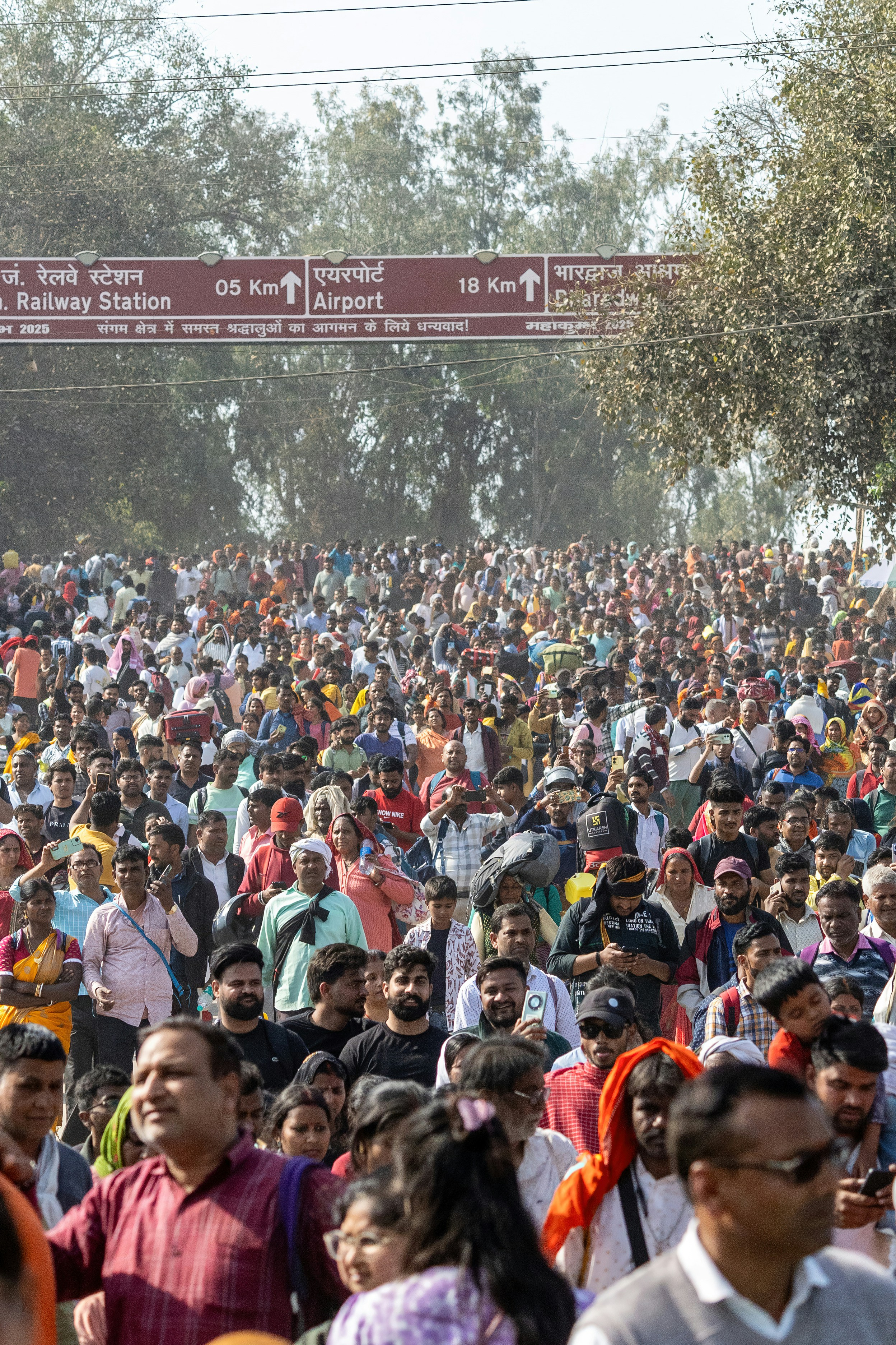 A large crowd of people gather in the street.