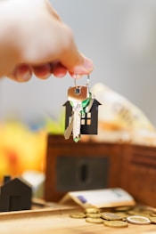 Here's a caption for the image: new house keys with money and a wallet.