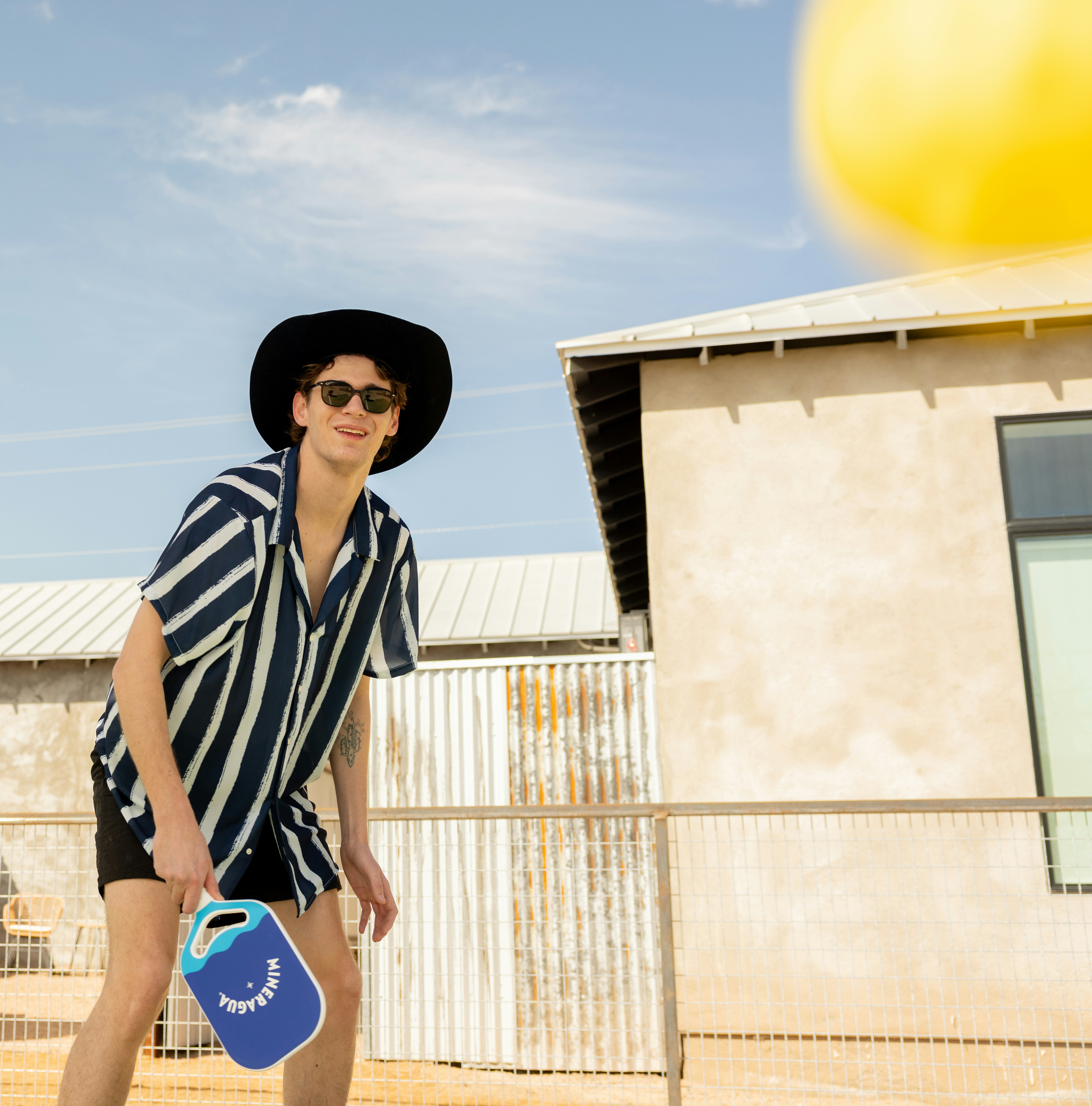 A man is ready to play outdoor pickleball.