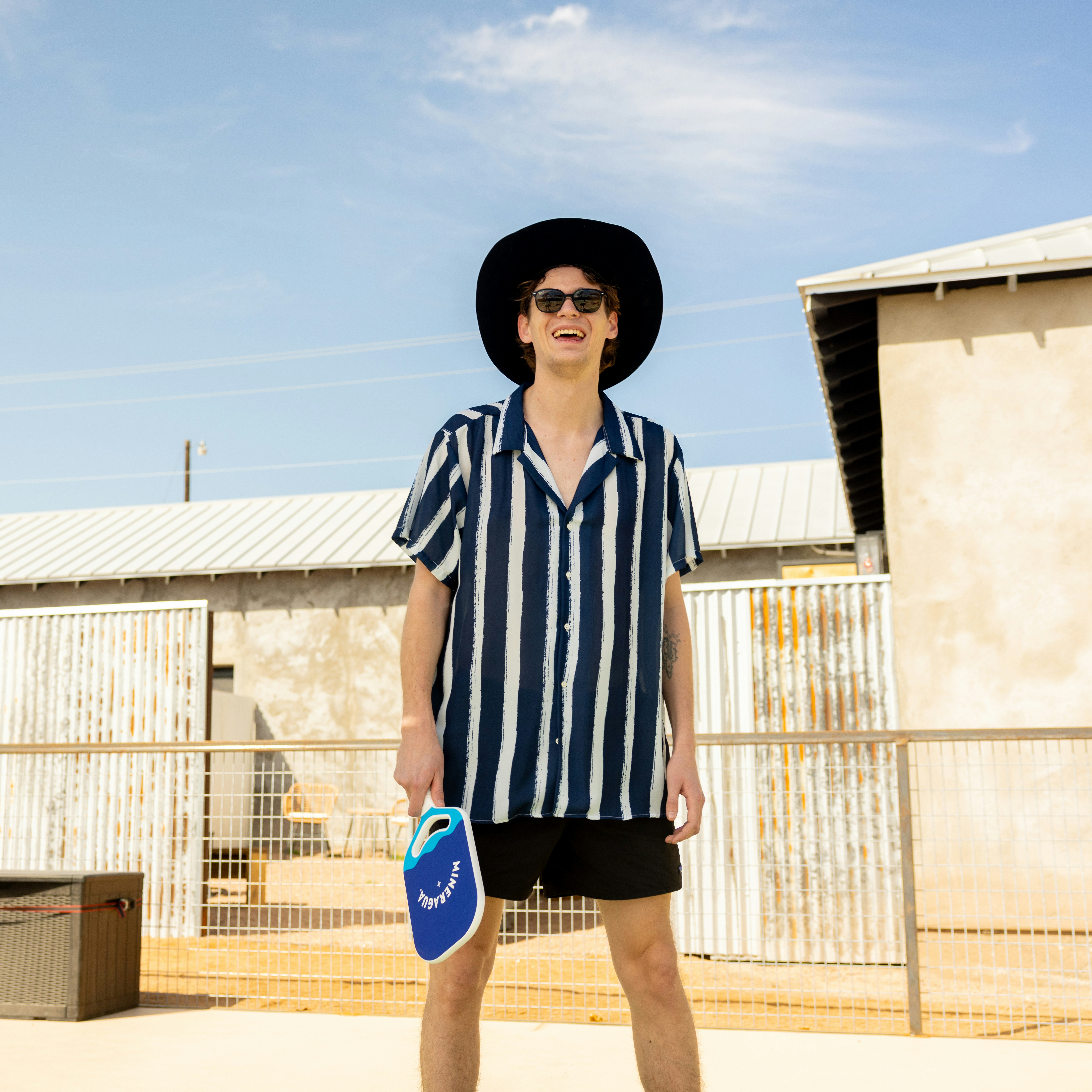 Man poses outside with a paddle.