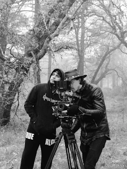 Filmmakers are working together in a forest