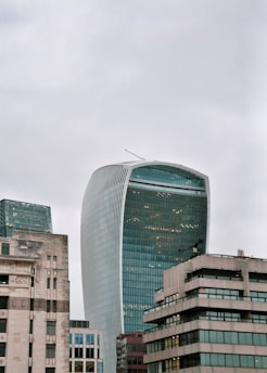 The london skyscraper dominates a cloudy sky.