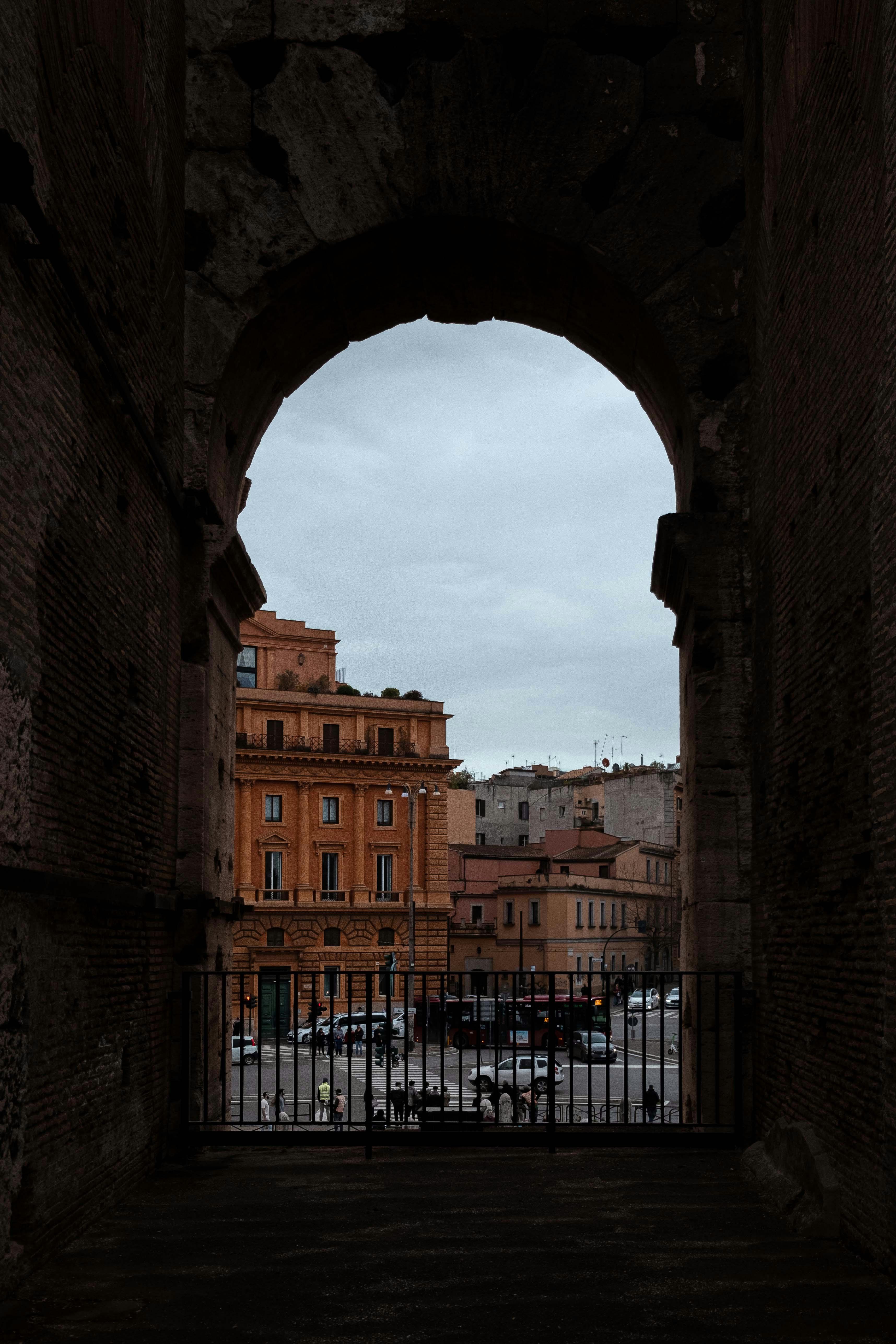 An arched window frames the city's buildings.