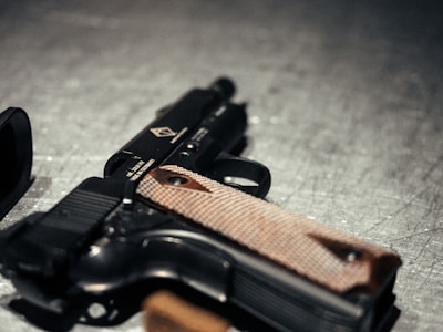 A handgun rests on a surface.