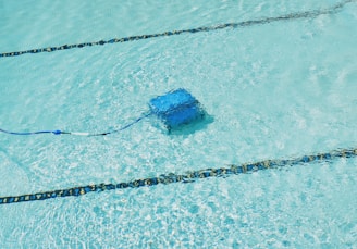 A robotic pool cleaner is working underwater.