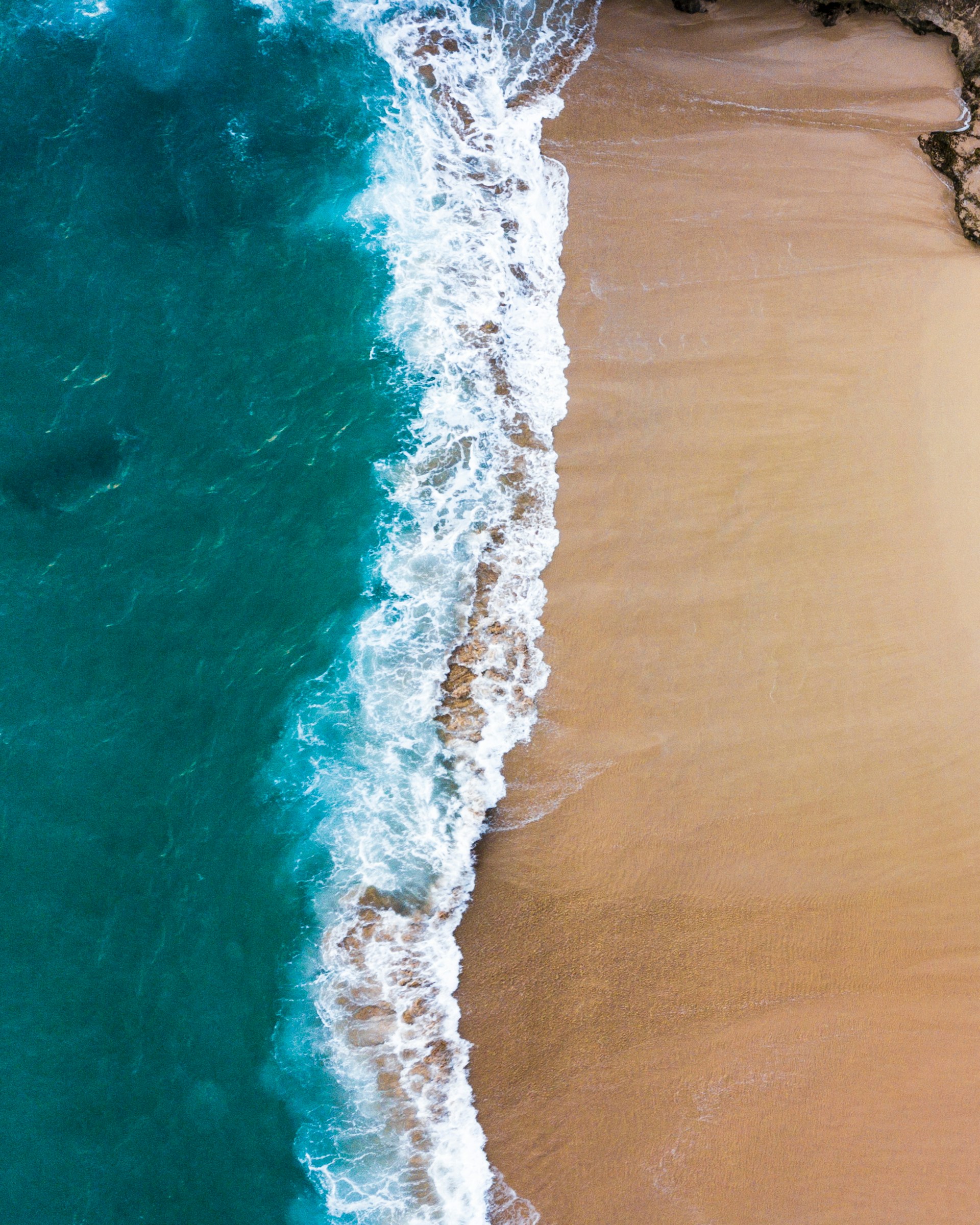 Waves crash onto a beautiful sandy beach.