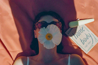 A woman with a flower covering her face.