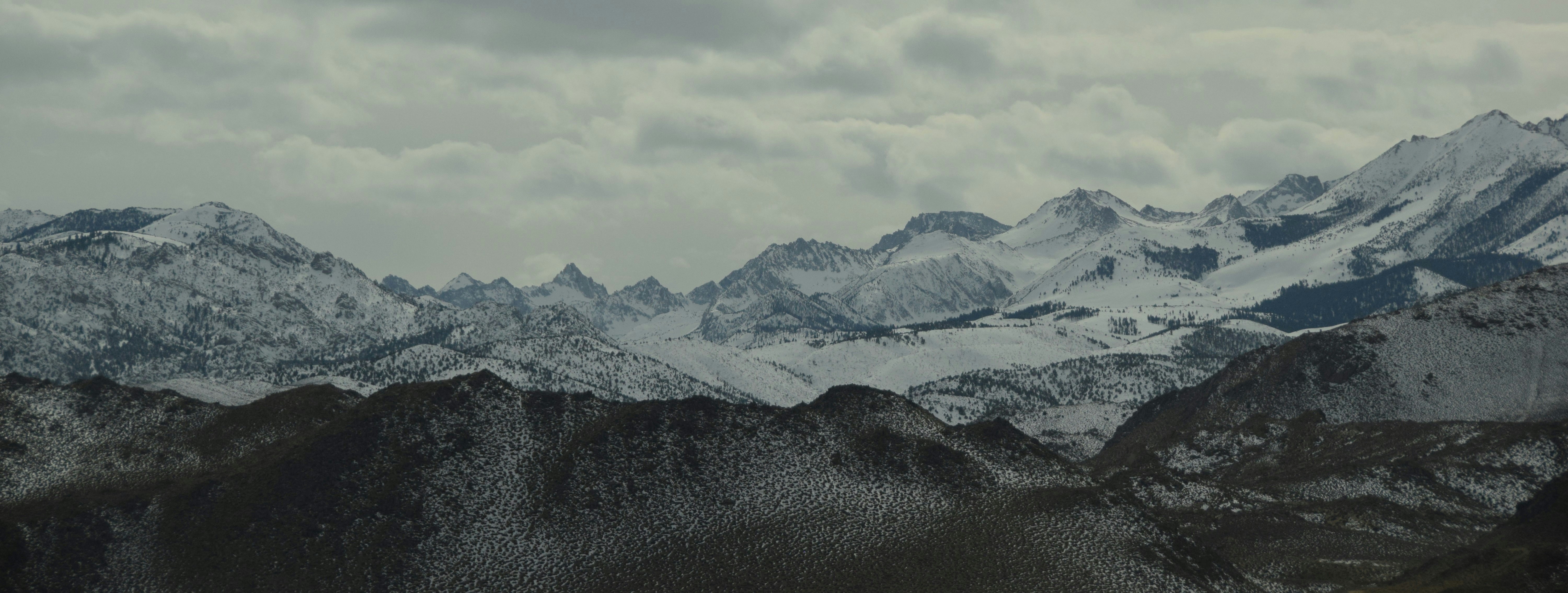 Snowy mountains under a cloudy sky.