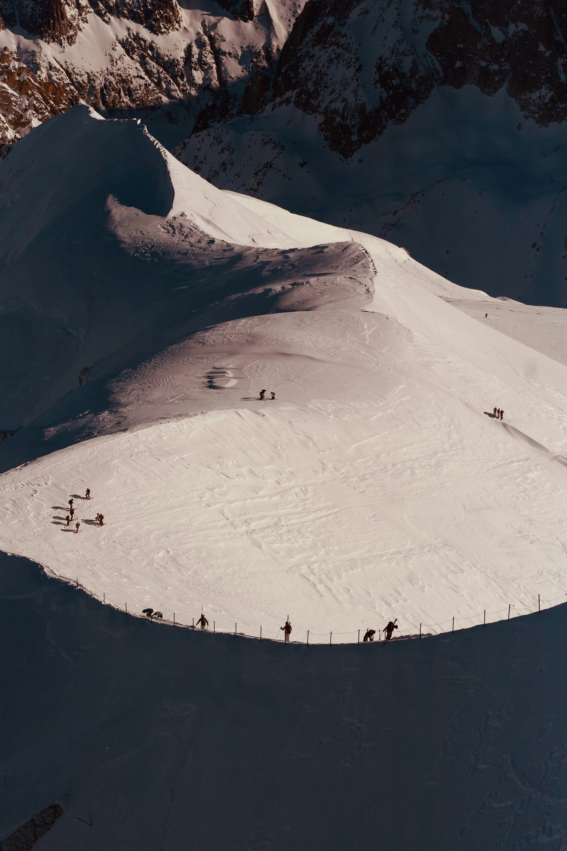 People are skiing on a snowy mountain slope.