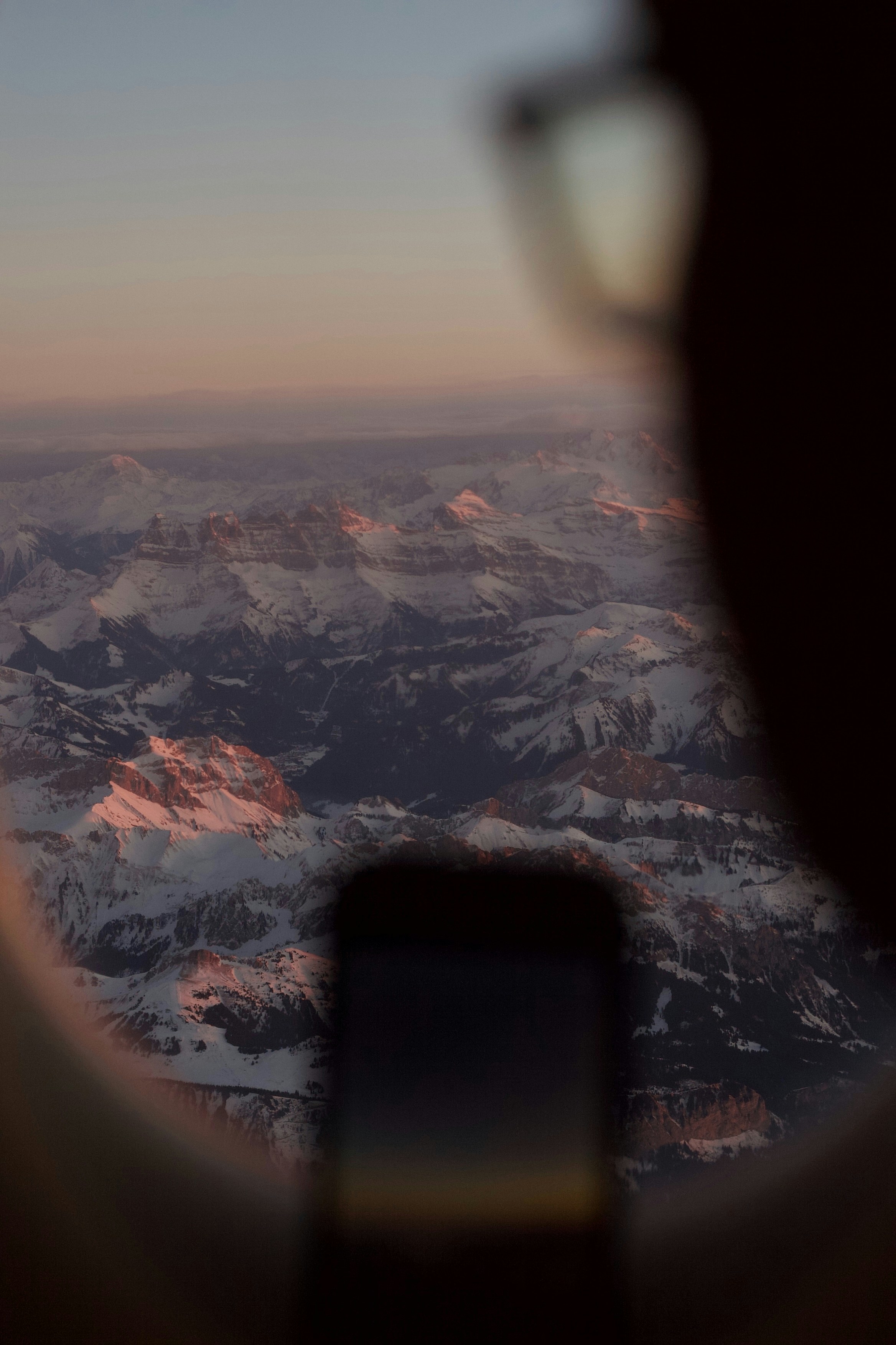 Mountains are seen from an airplane window.