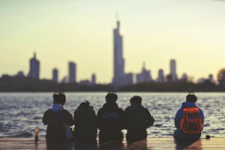 People watch the city skyline at sunset