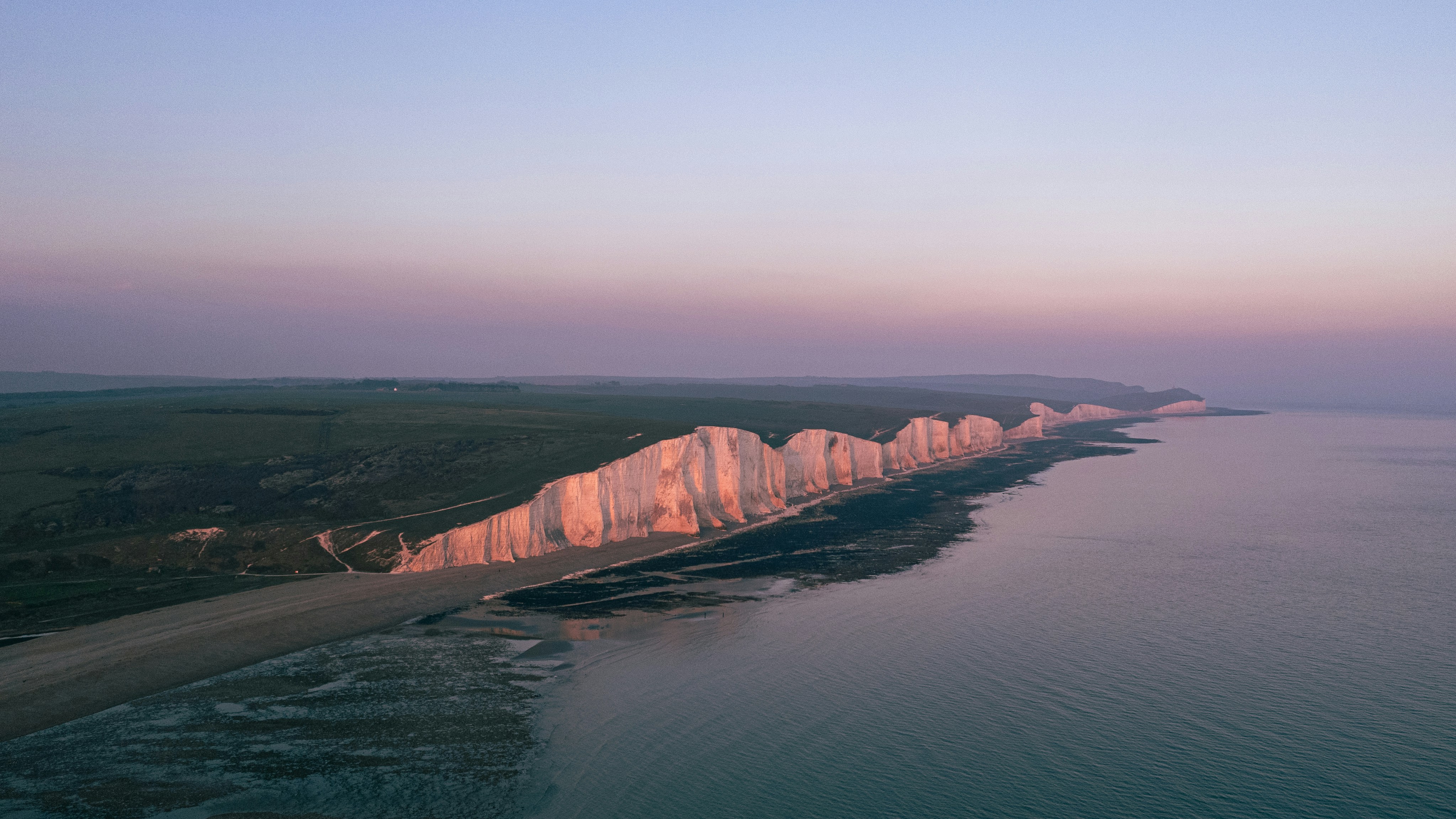 White cliffs and shoreline at dusk.