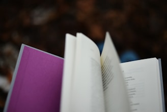An open book with purple binding.