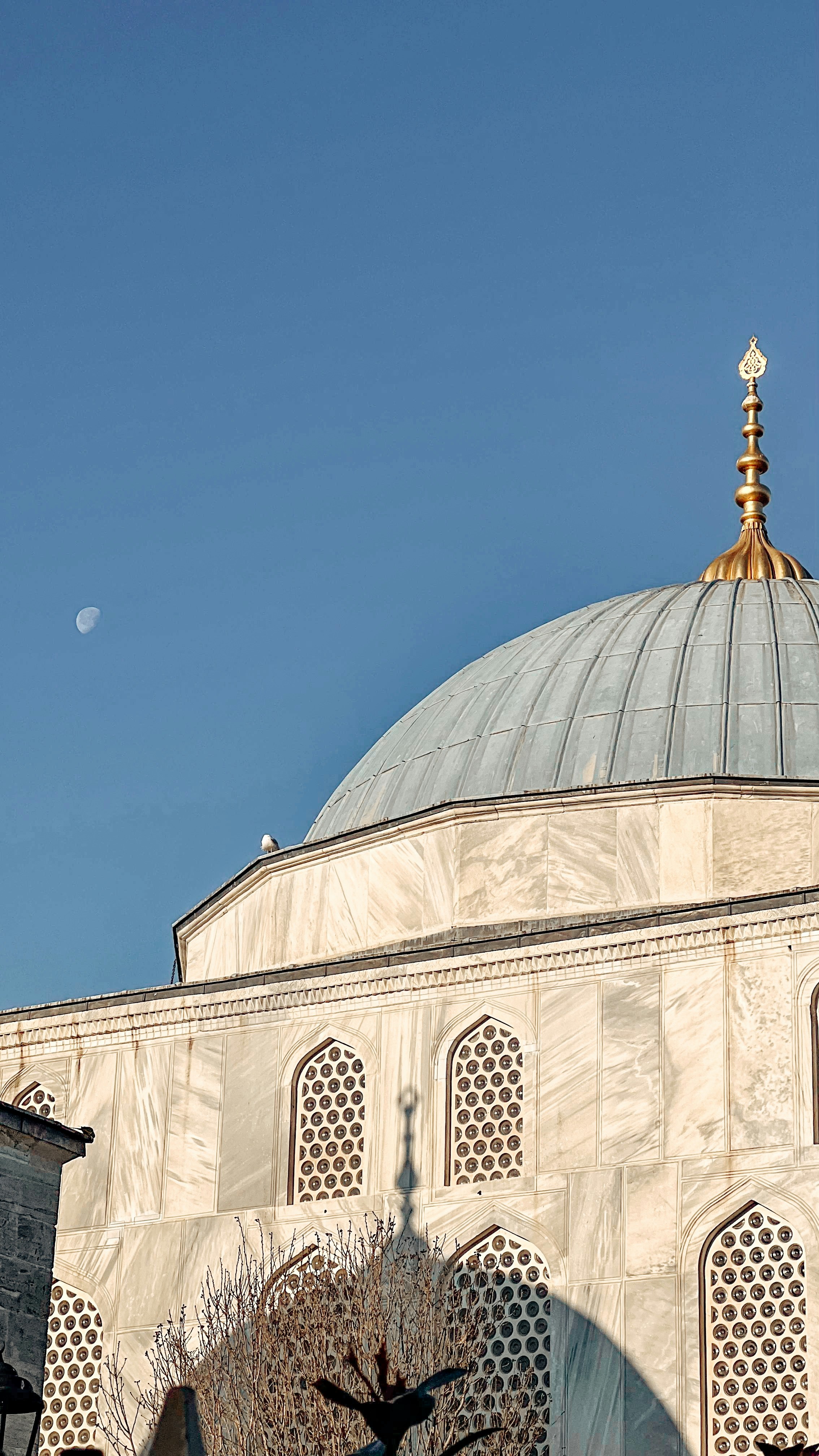 Mosque dome against a clear blue sky.