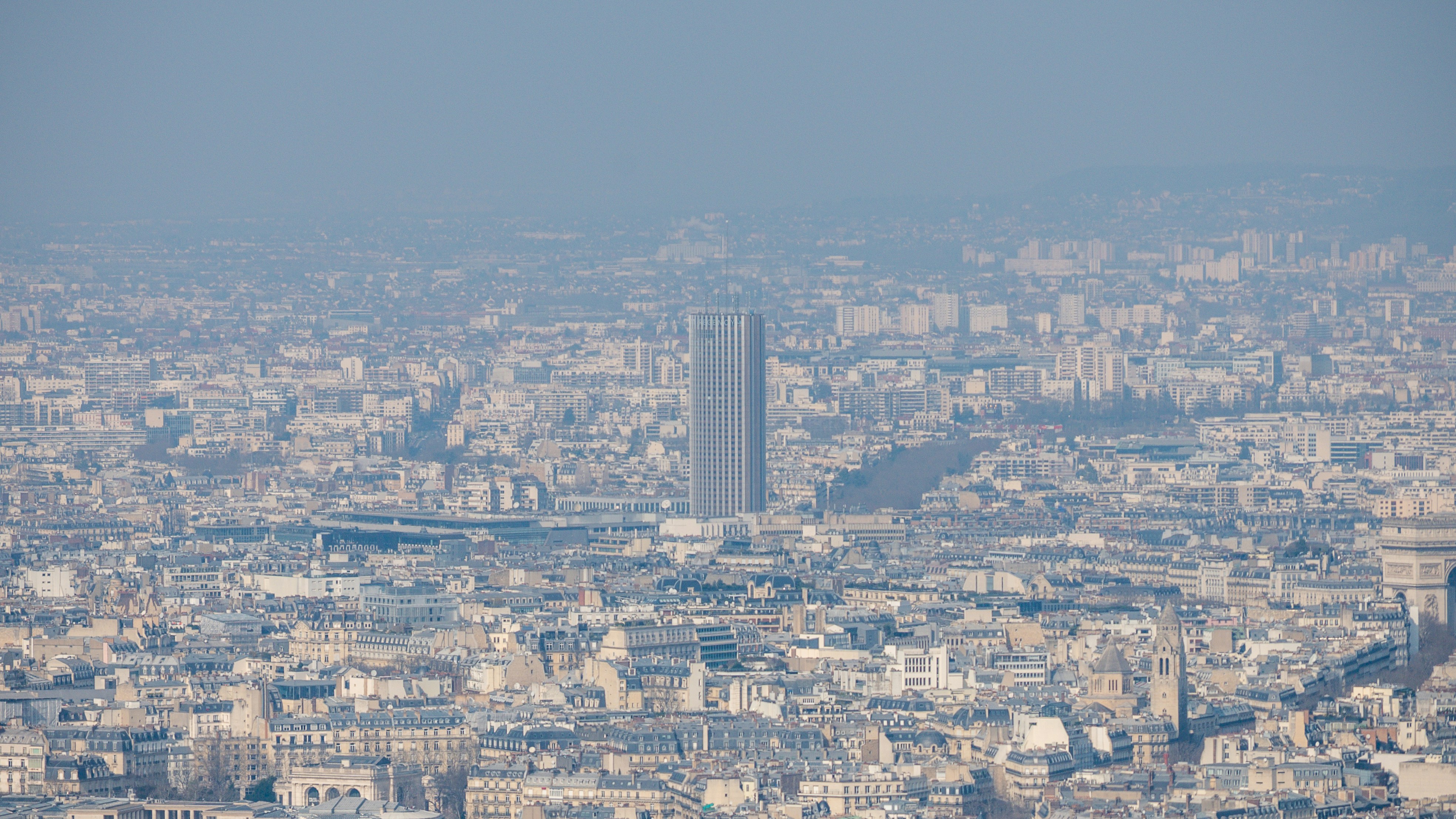 A tall building dominates a dense cityscape.