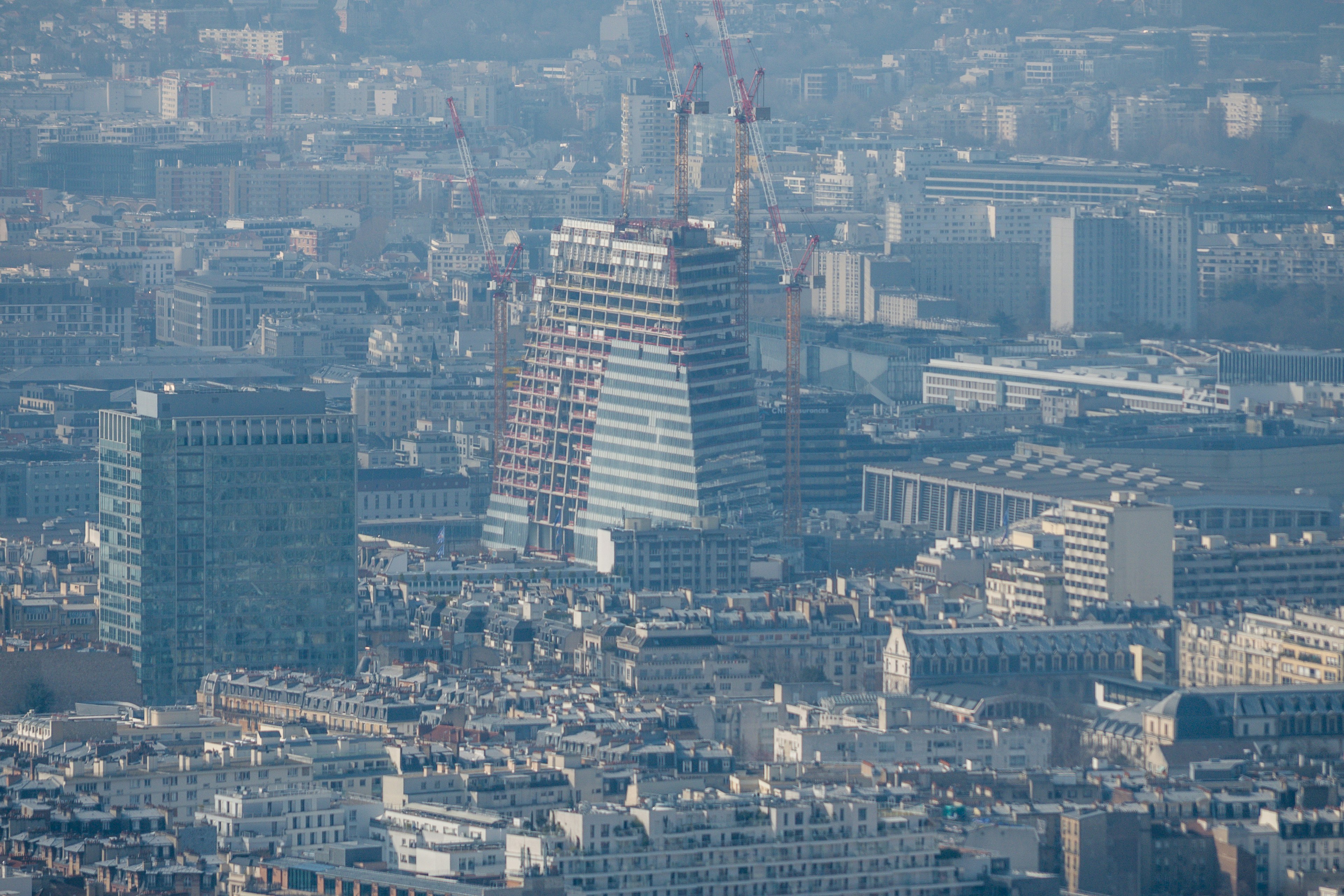 Modern skyscrapers tower over a dense cityscape.