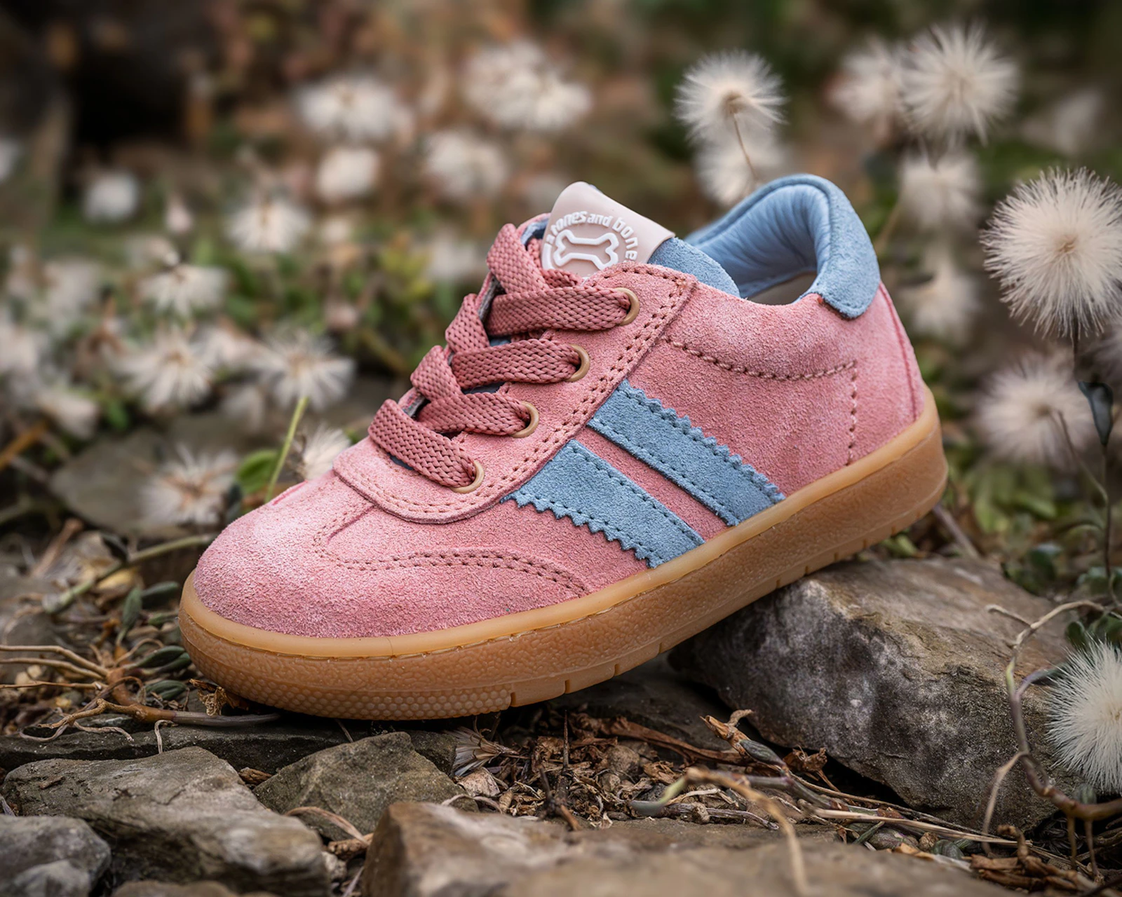 Pink and blue children's sneaker styled outdoors with soft natural details