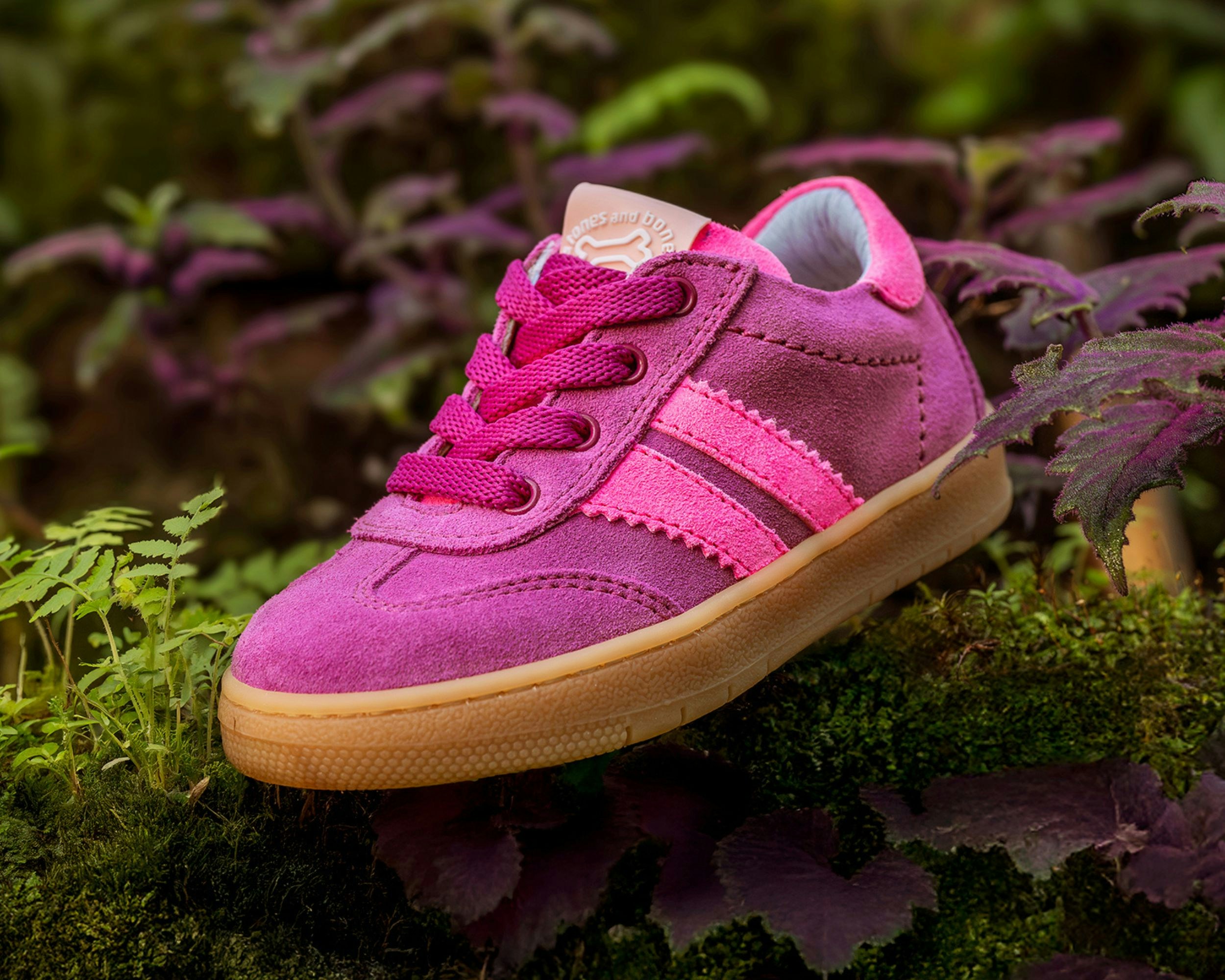 Pink shoe on greenery