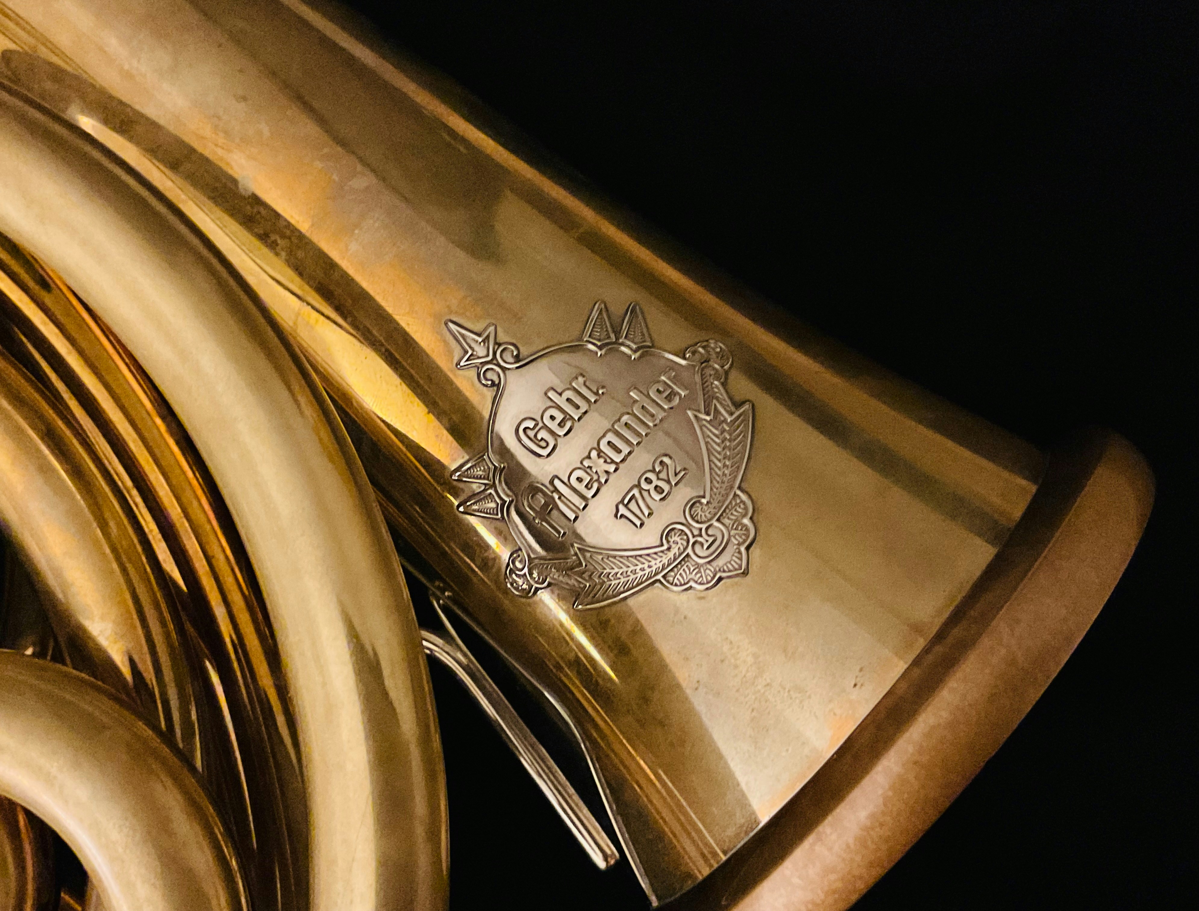 Close-up of a brass instrument with a logo.