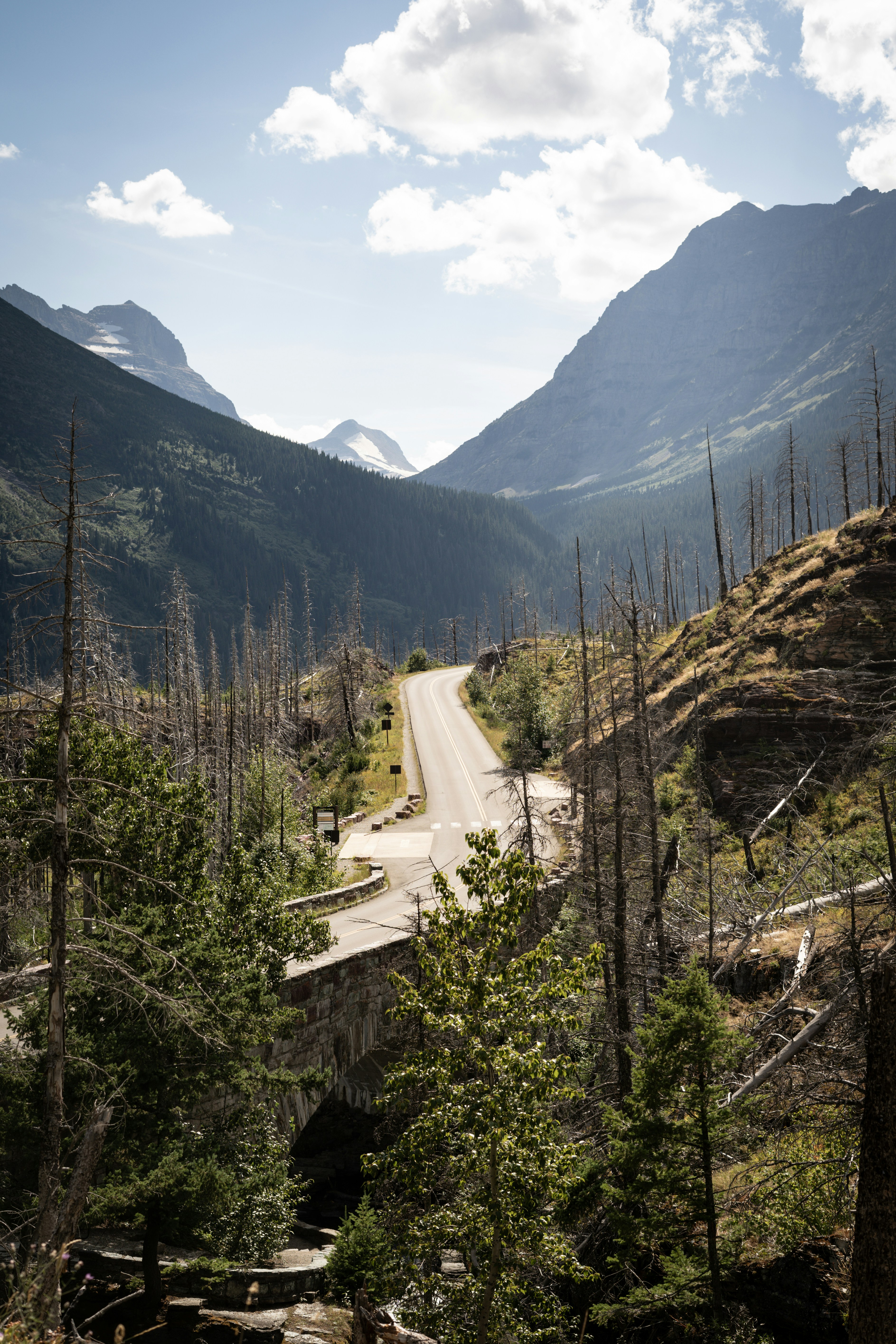 A winding road leads through a mountain valley.