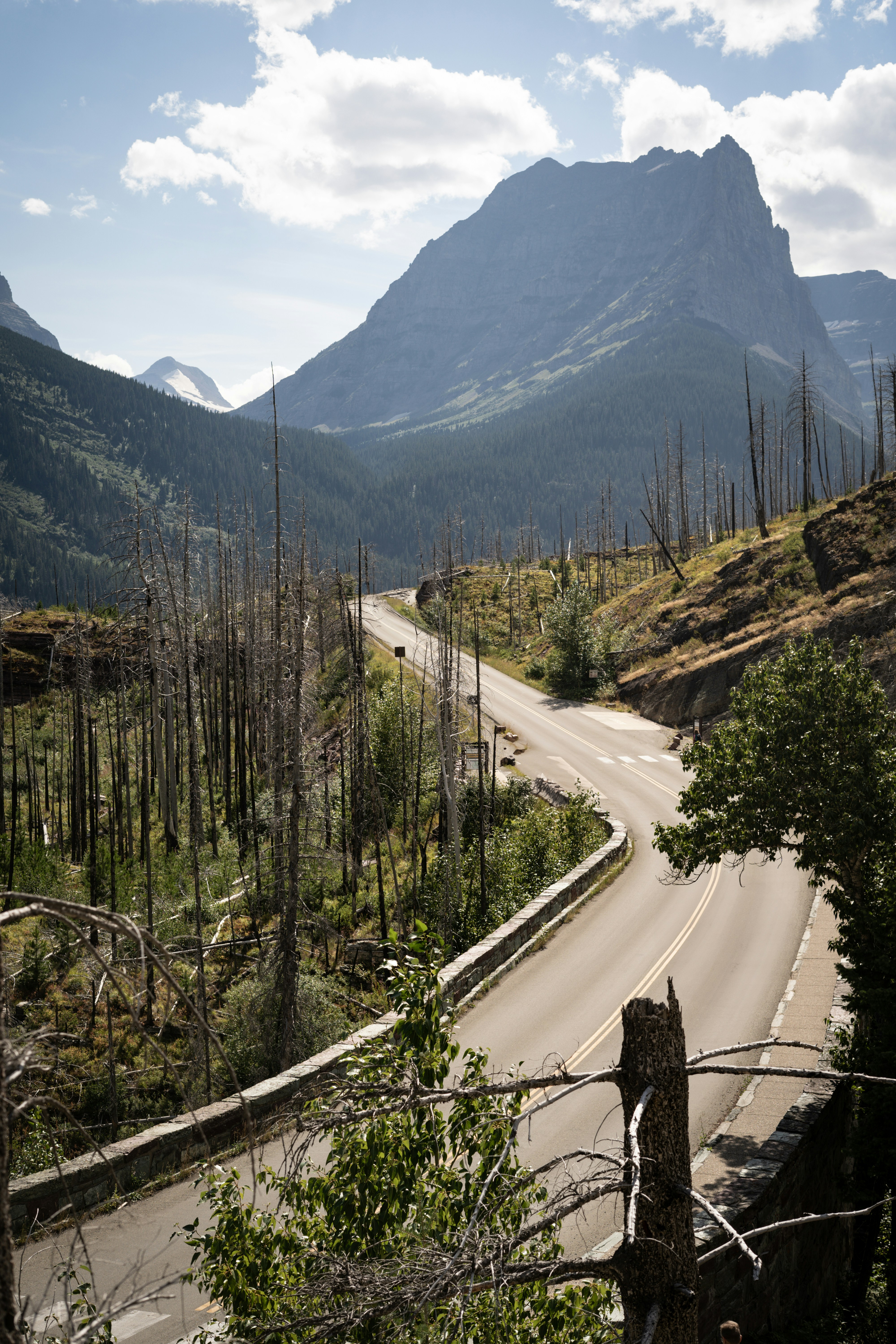 Winding road leads into a beautiful mountain landscape.