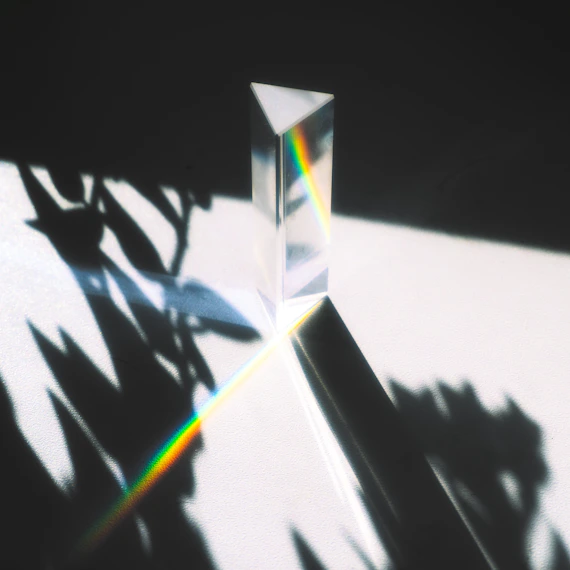 A prism refracts light into a rainbow spectrum.