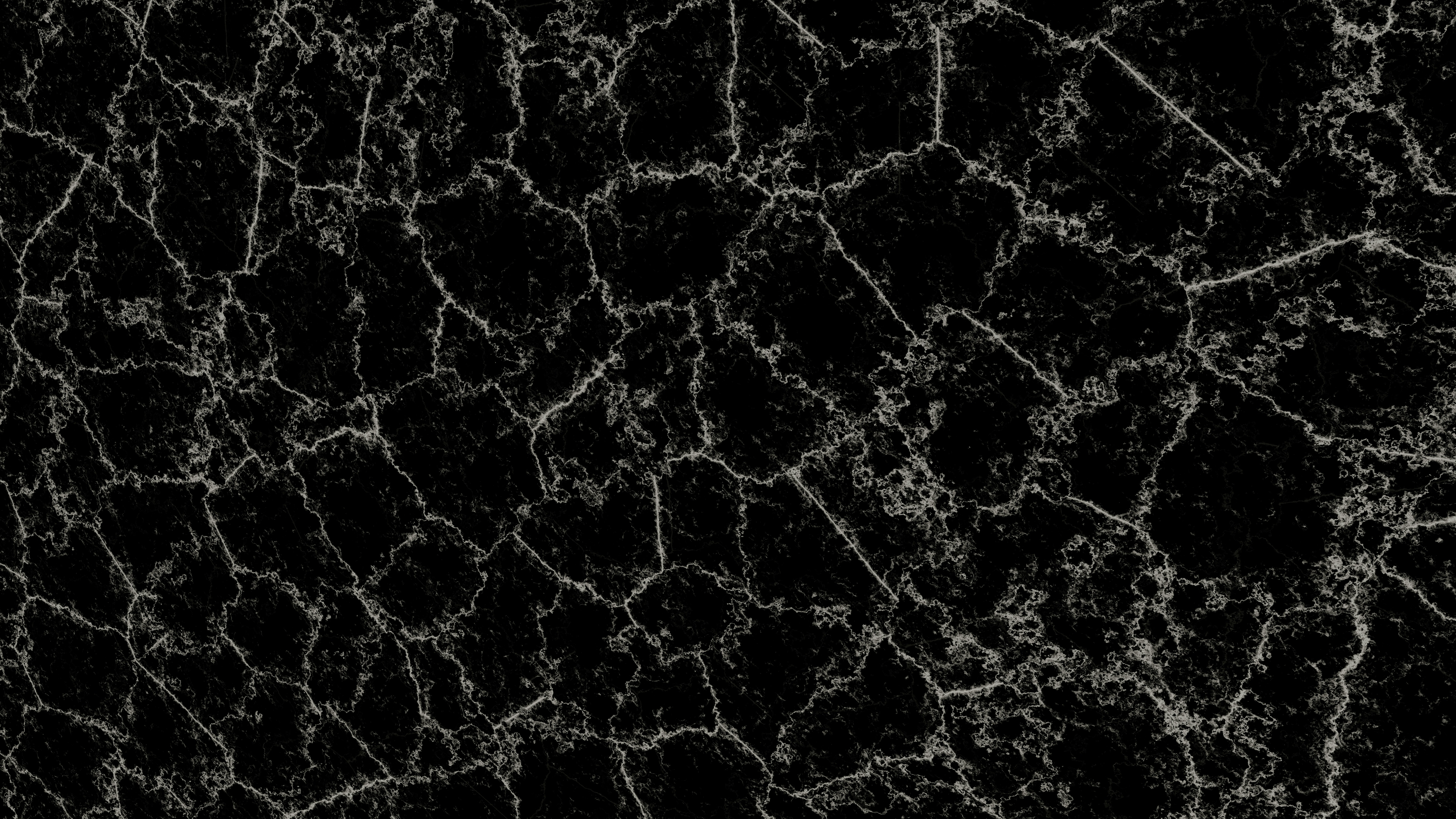 Dark surface with a cracked, geometric pattern.