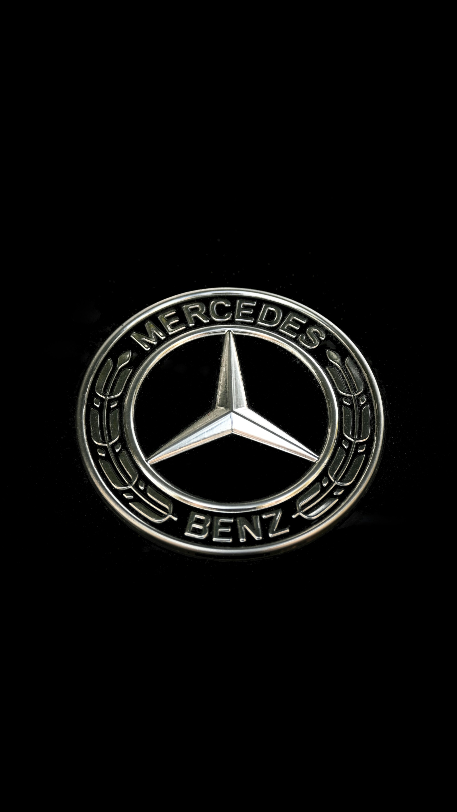 The mercedes-benz logo on a black background.
