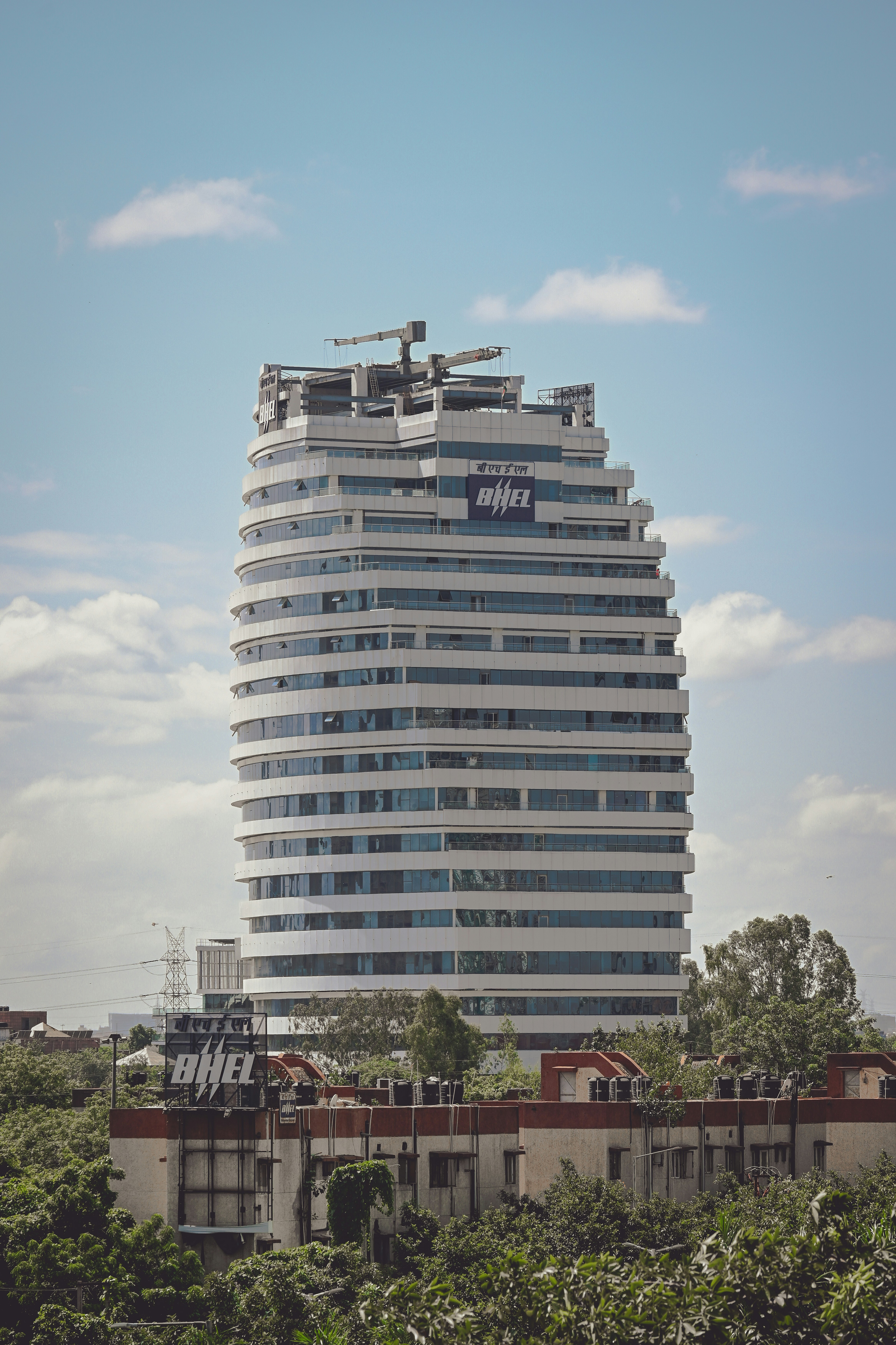 Modern, white building reaches up to the sky.