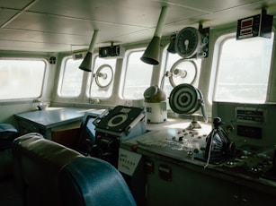 Inside the ship's bridge, navigation instruments visible.