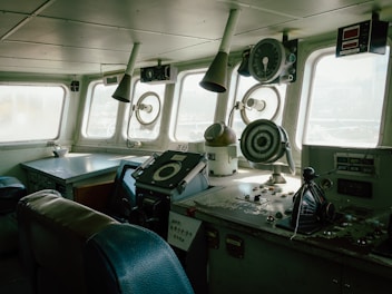 Inside the ship's bridge, navigation instruments visible.