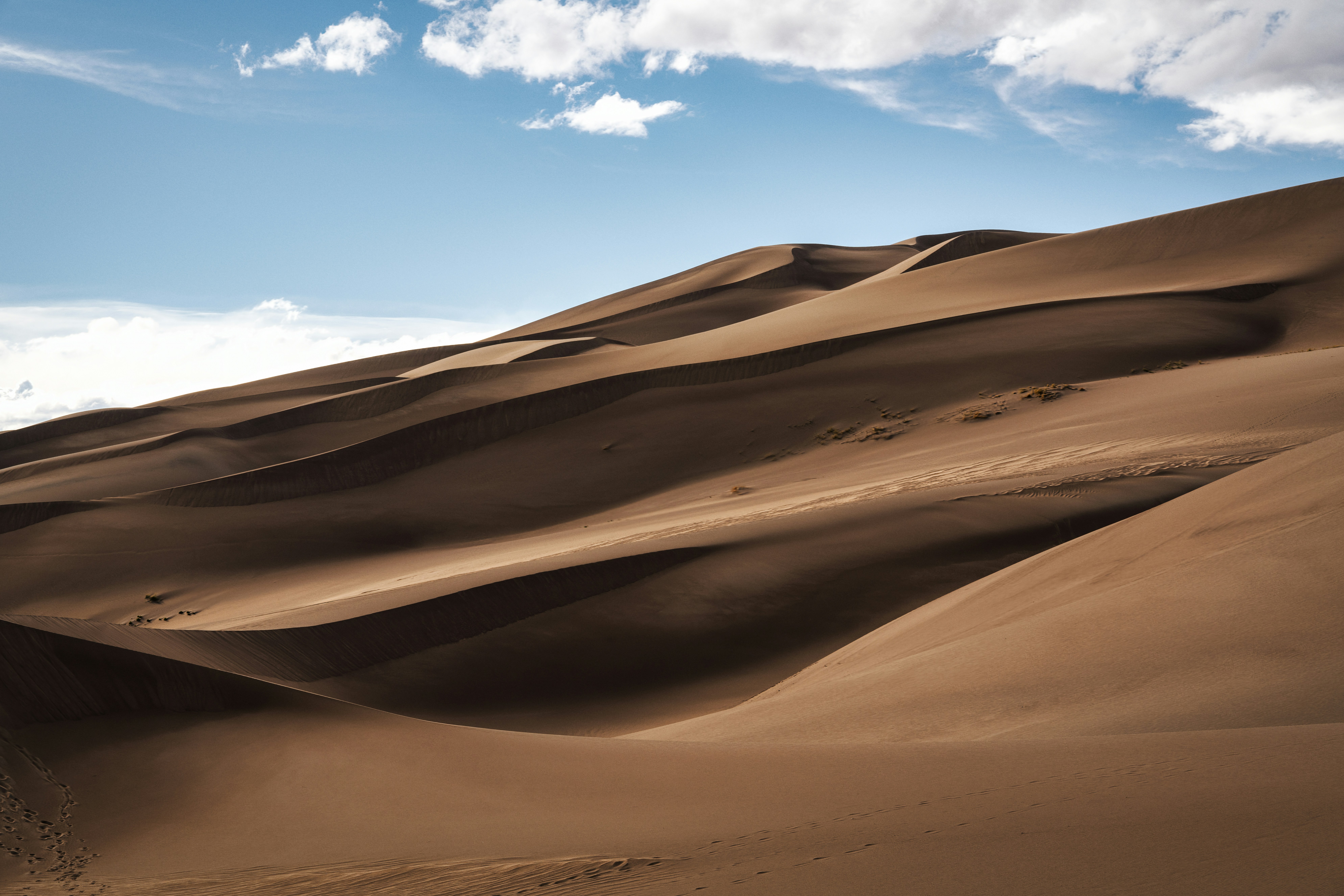 Sand dunes stretch across the arid landscape.